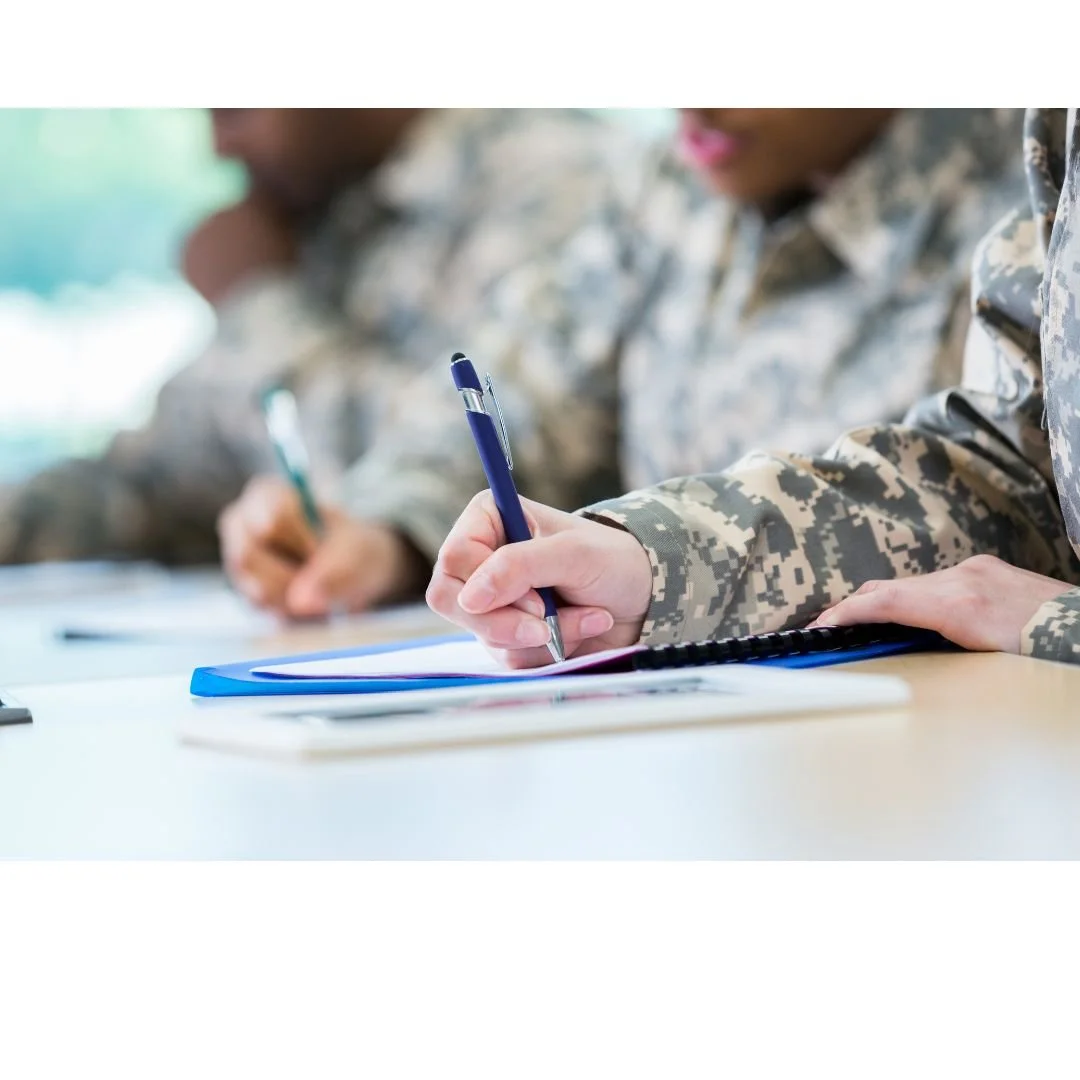 veterans writing at desk