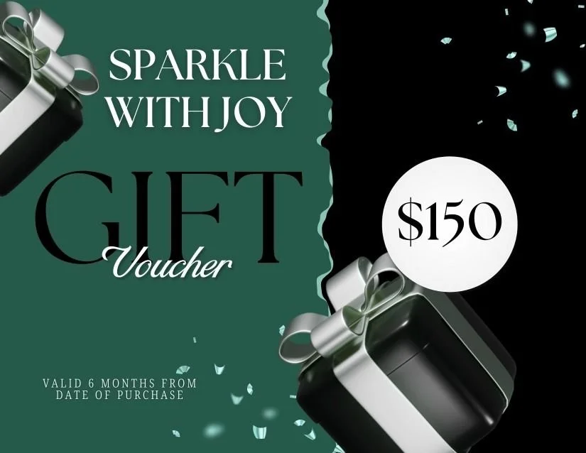 A gift card with a black and silver gift box with a silver ribbon, surrounded by confetti. Text on the card reads "Sparkle with Joy Gift Voucher," valued at $150, valid for six months from the purchase date.