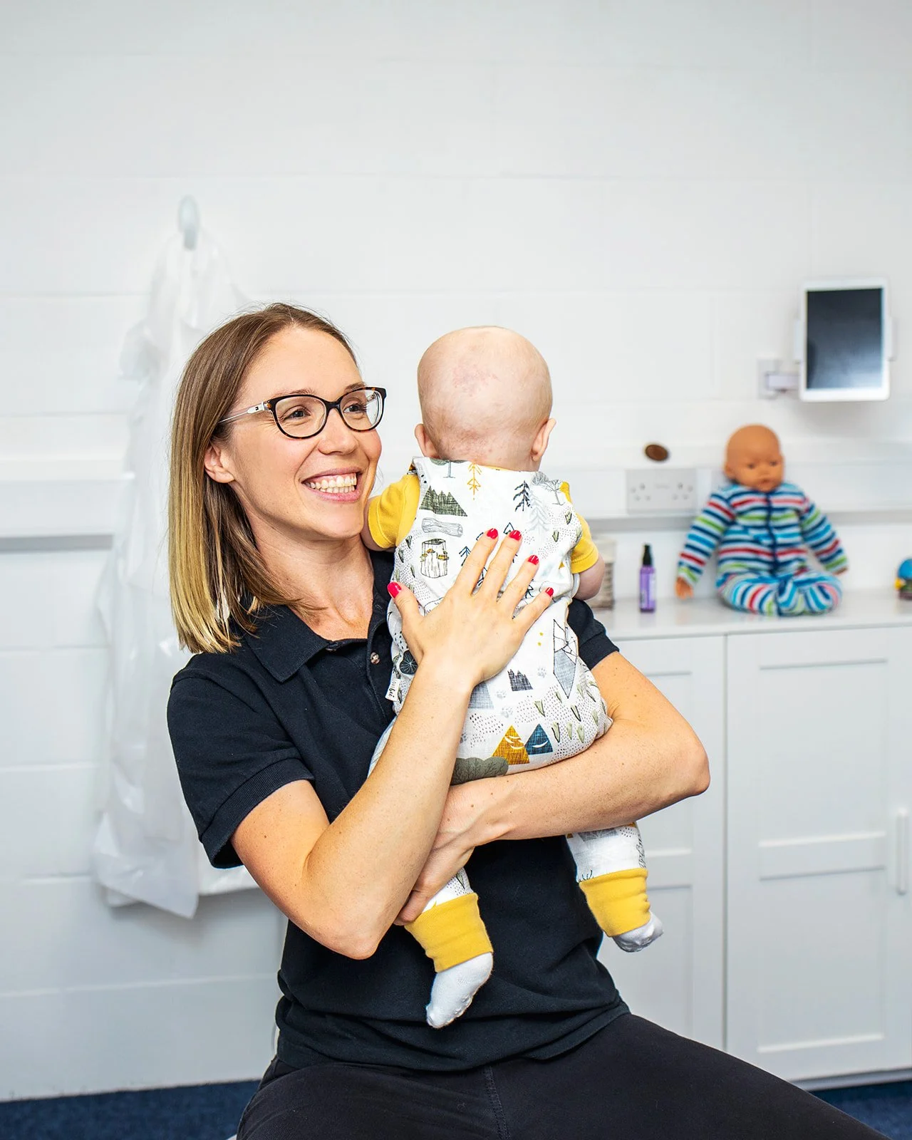 Sarah Keen providing a baby with a gentle chiropractic adjustment.