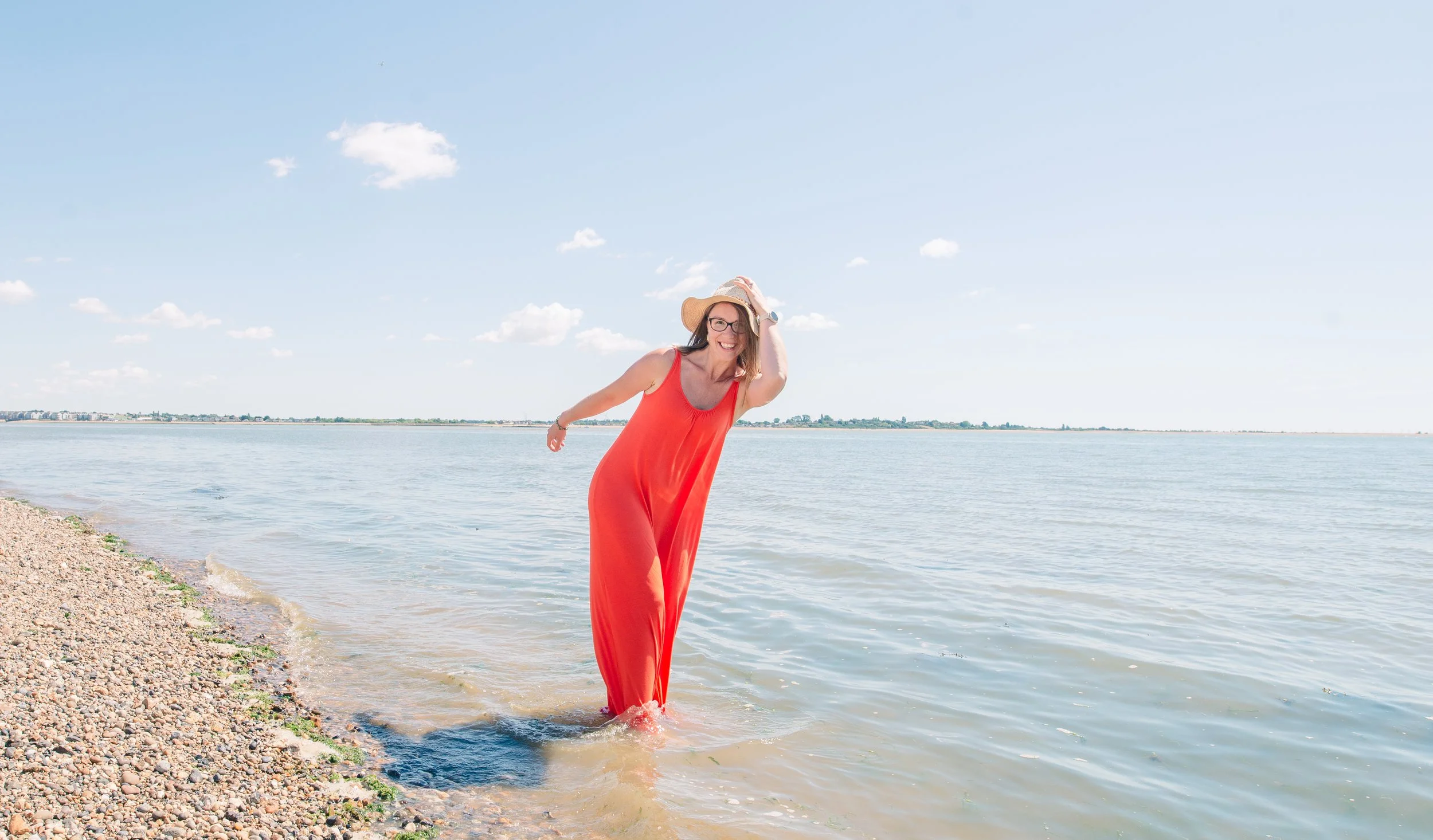 Sarah Keen, Colchester chiropractor and coach, smiling at Mersea Island beach in Essex