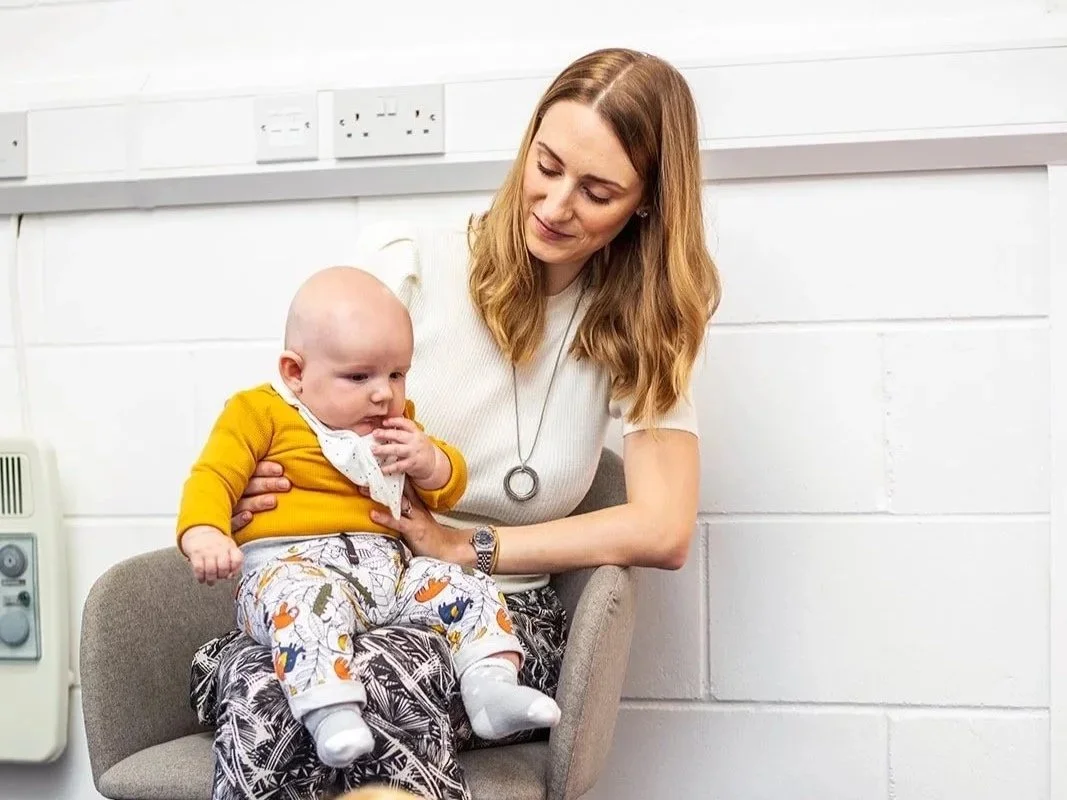 A mum and baby waiting at Lightbulb Chiropractic.