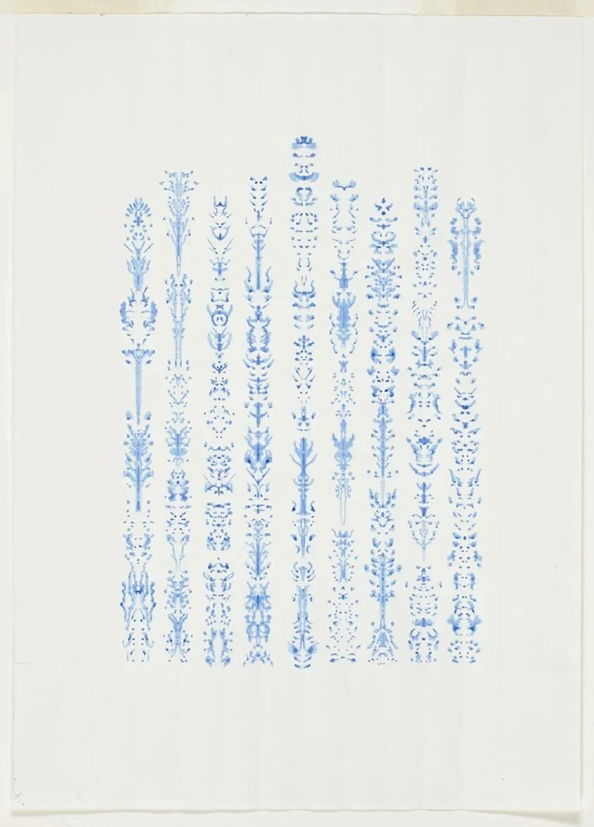 Abstract blue floral pattern on white paper.