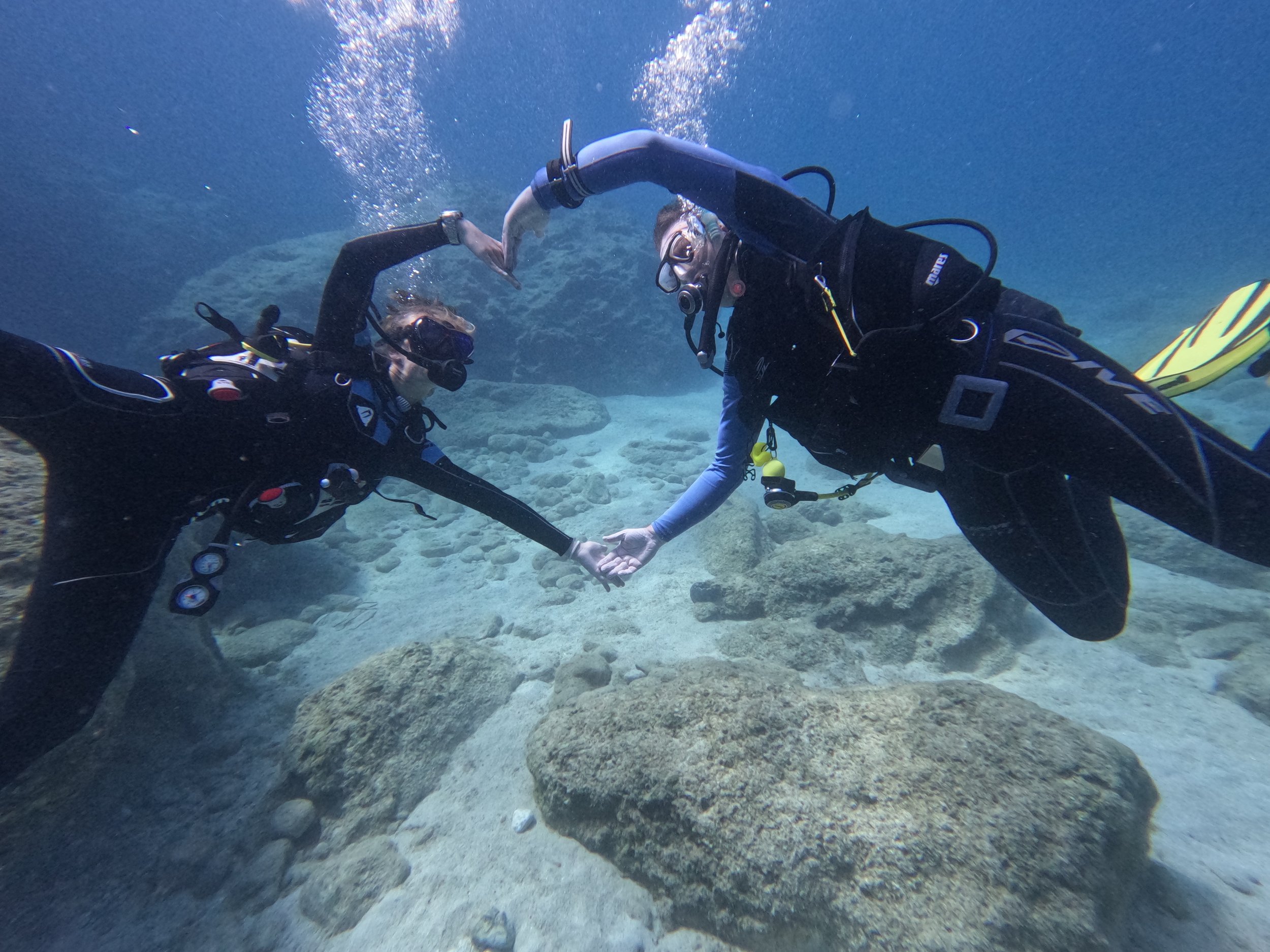 Scuba diver buddies doing heart showing their love to Scuba diving in Zakynthos.