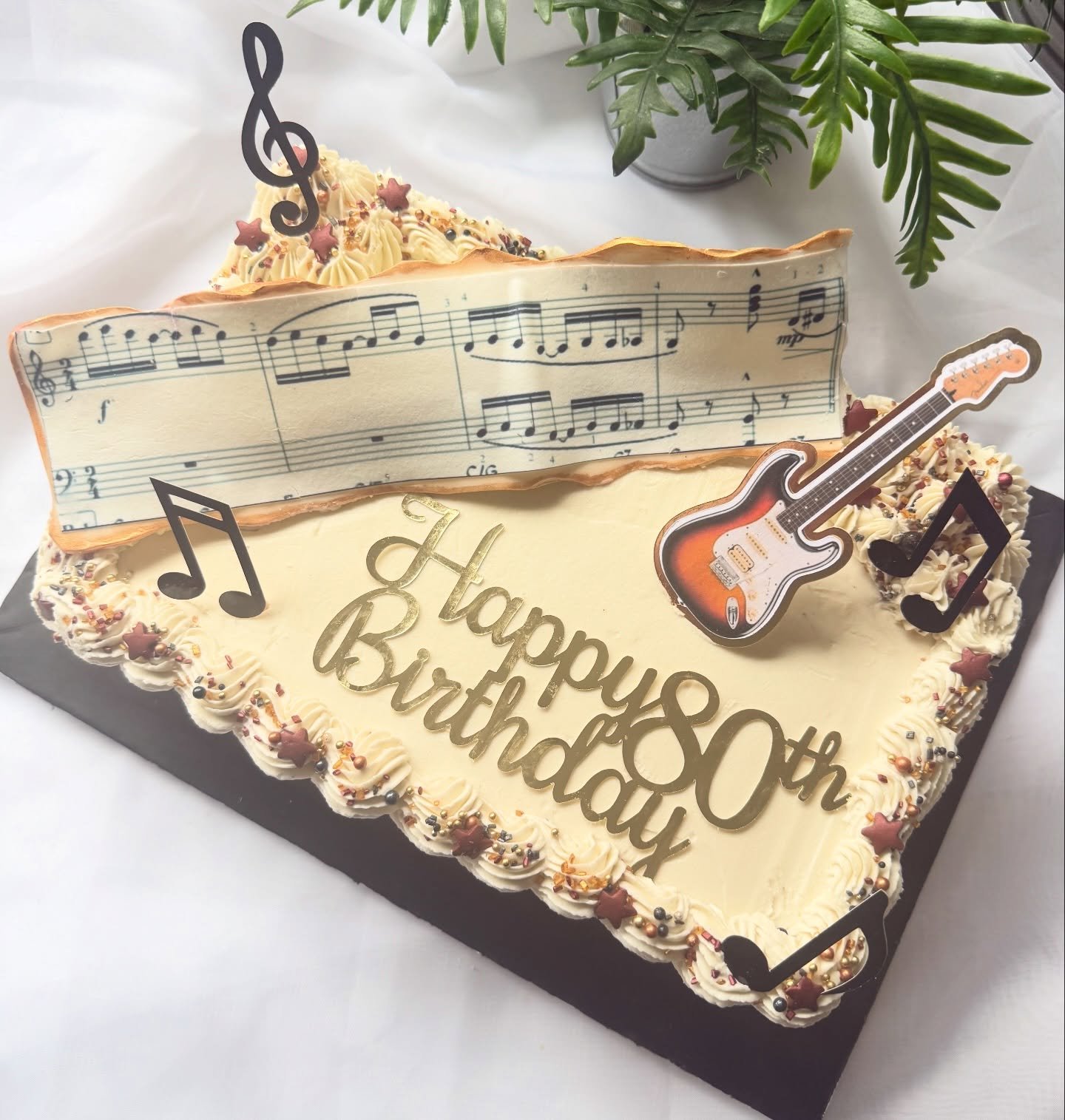 A story of a man, his love for music, and memories of life with his guitar 🎸 

Two layers of soft sponge, filled and topped with rich ganache and buttercream, finished with an edible sheet of music, delicate gold edging, and a keepsake topper of his