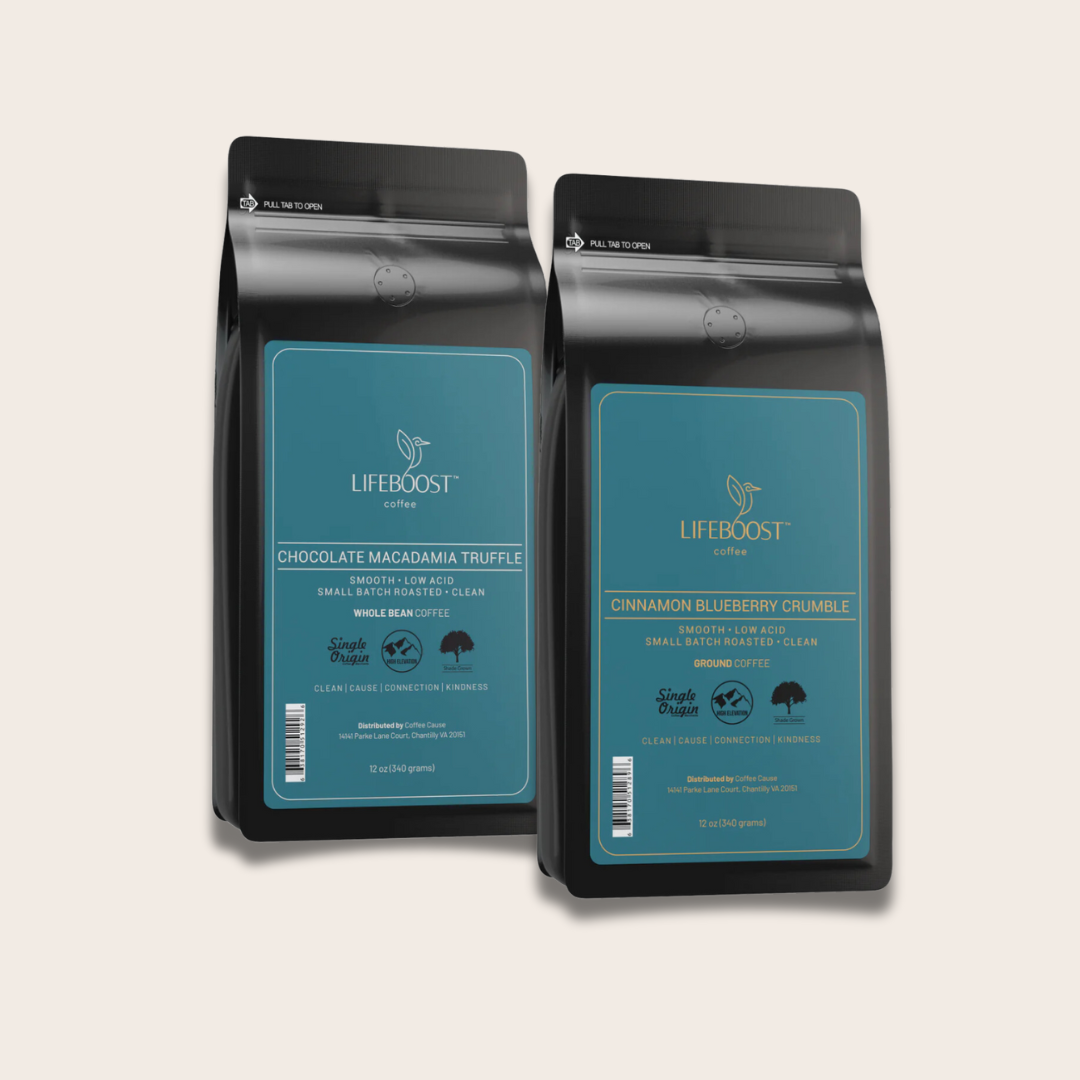 Two bags of Lifeboost coffee, one chocolate macadamia truffle flavor and one cinnamon blueberry crumble flavor, standing side by side against a neutral background.