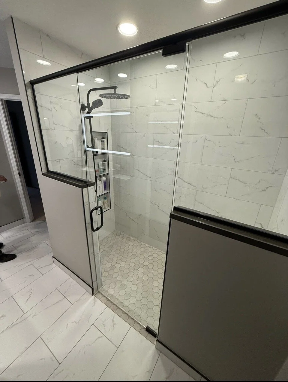 tile shower white and black with frameless glass door custom niche with bench zero grade entry