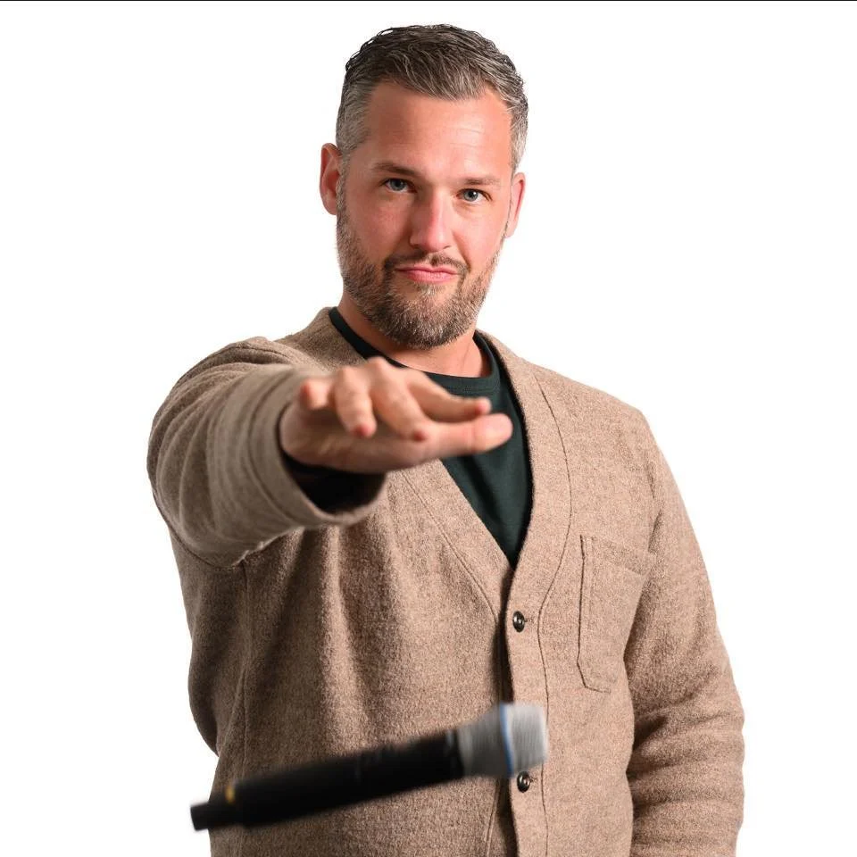 Seth Lieber emceeing a live event with microphone
