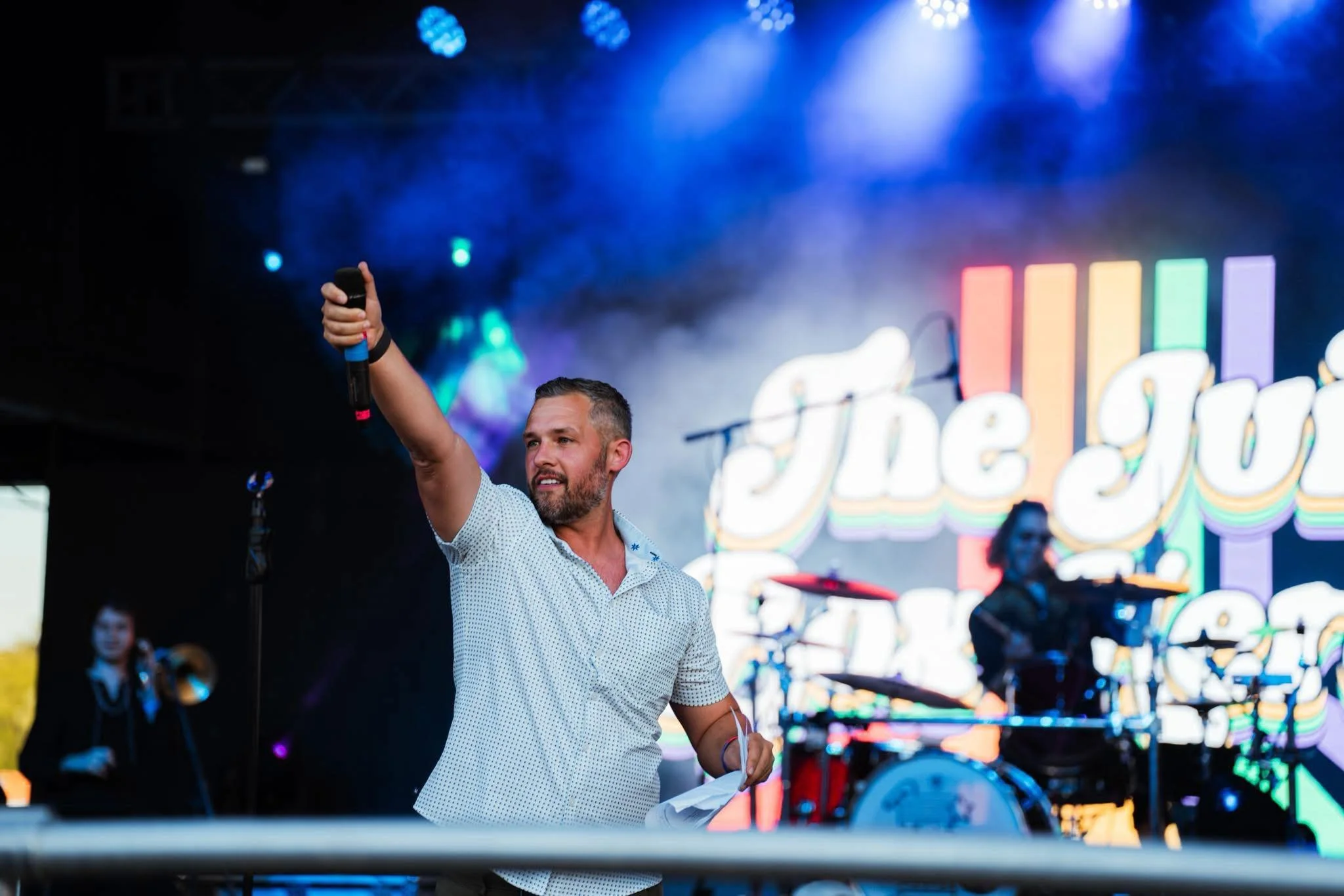Seth Lieber hosting a live event on stage with microphone