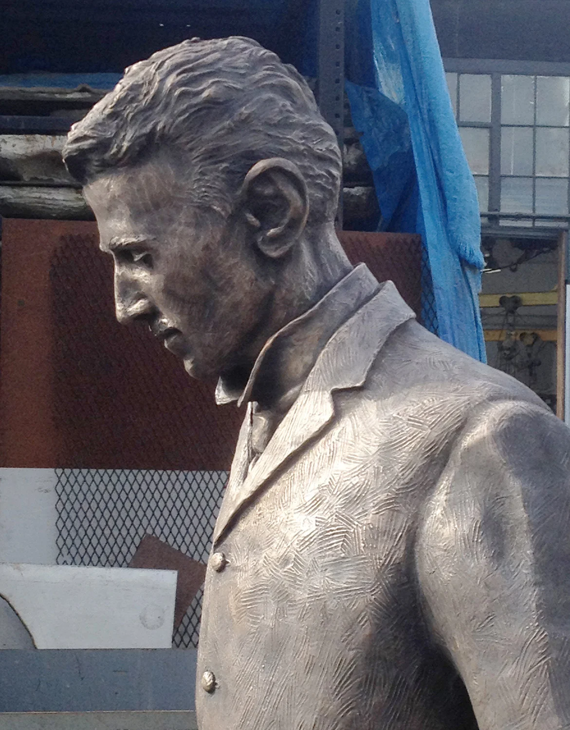 Detail of of the Nikola Tesla statue head and shoulders during patina process at Artworks Foundry in Berkeley California.