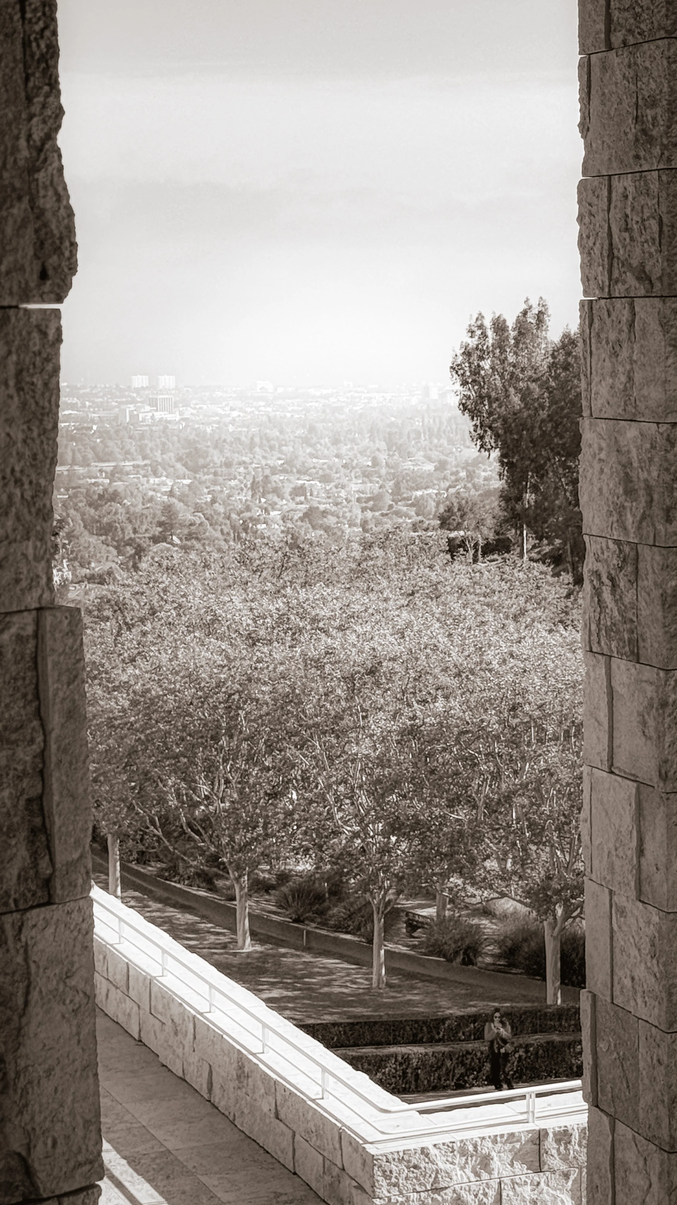 View of Los Angeles through stone columns, evoking intimate Human Design gatherings in the city