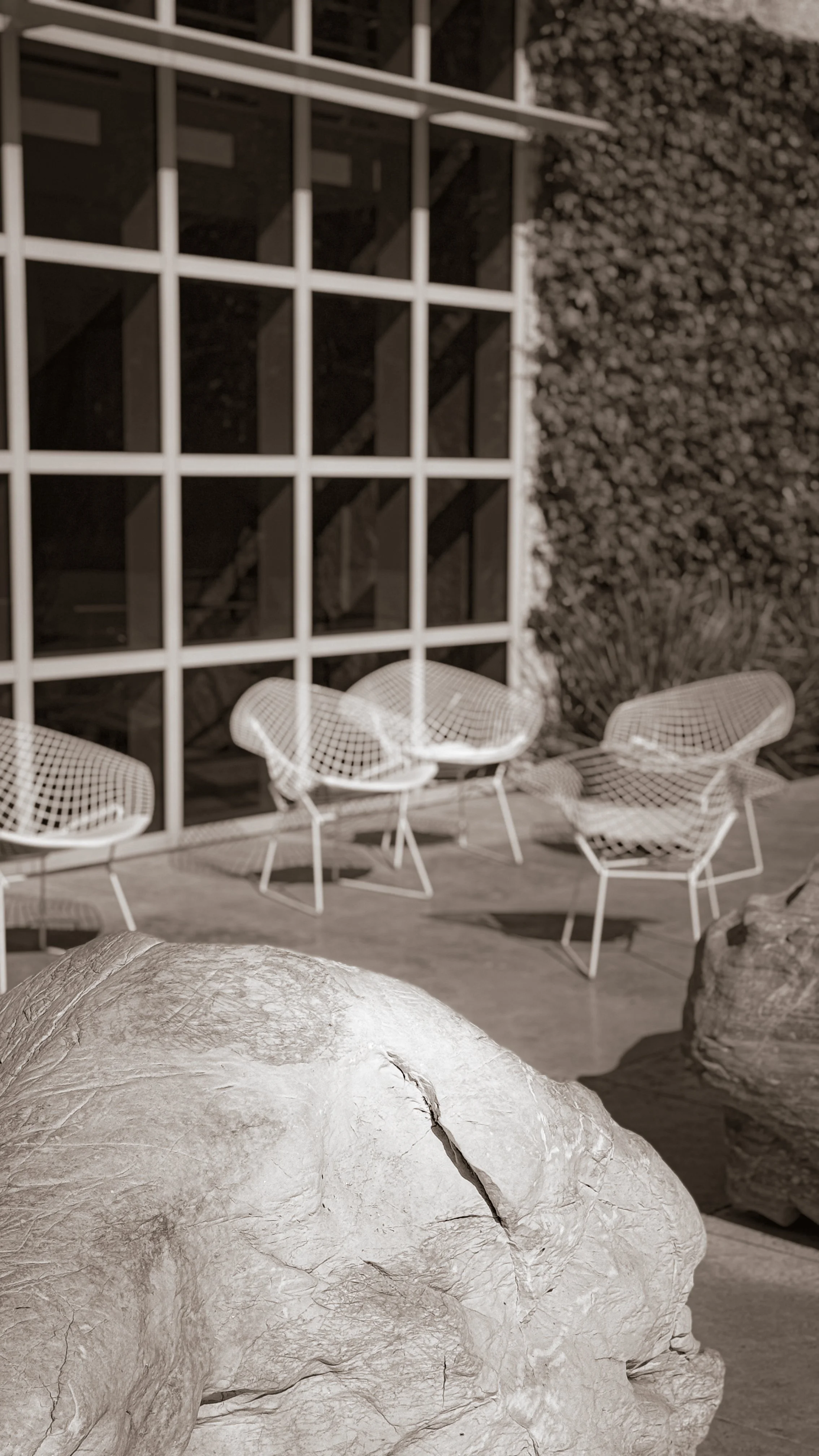 Empty chairs arranged in an intimate outdoor space, setting the scene for a private Human Design event