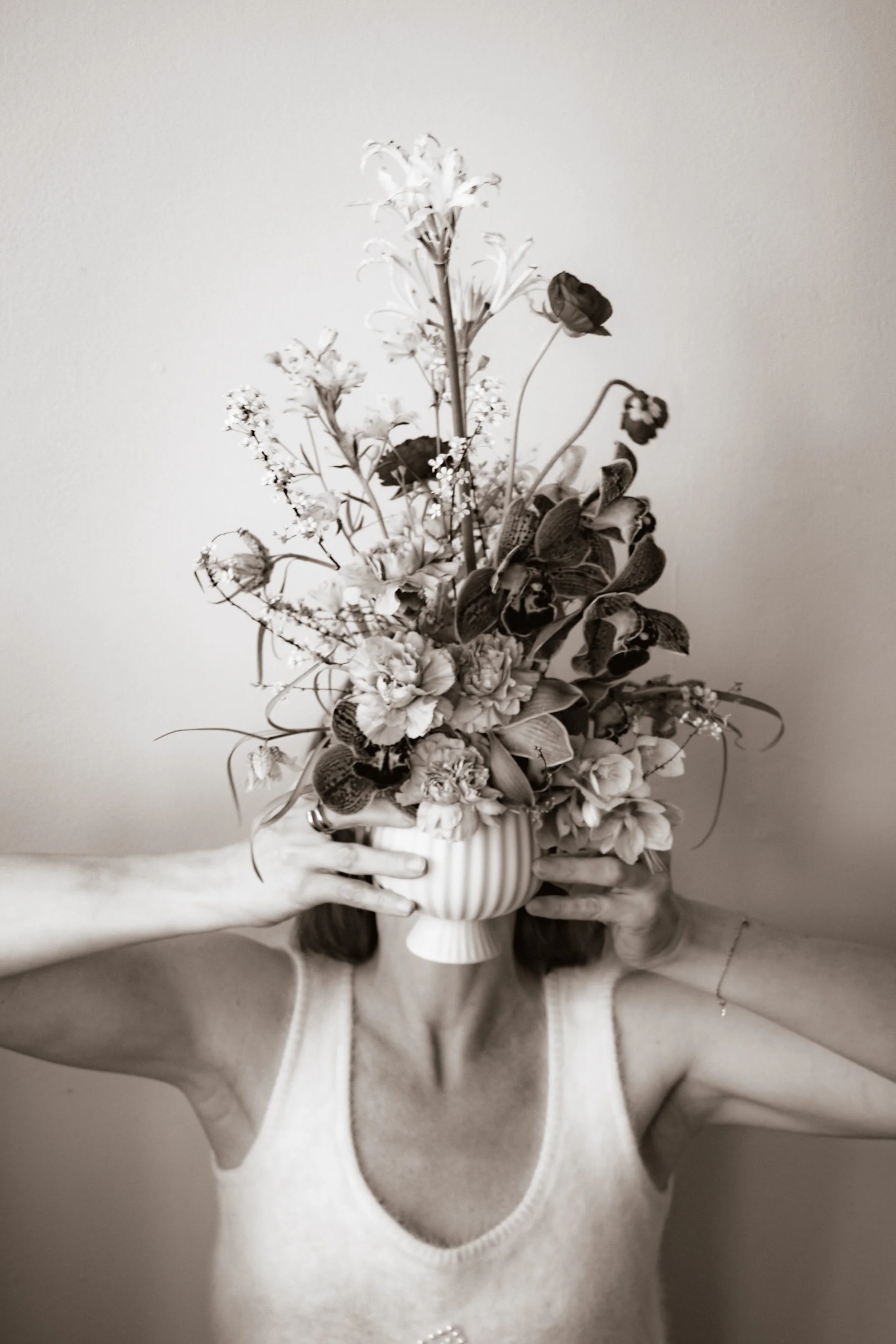 Person holding an abundant floral bouquet, representing the gift of a Human Design session