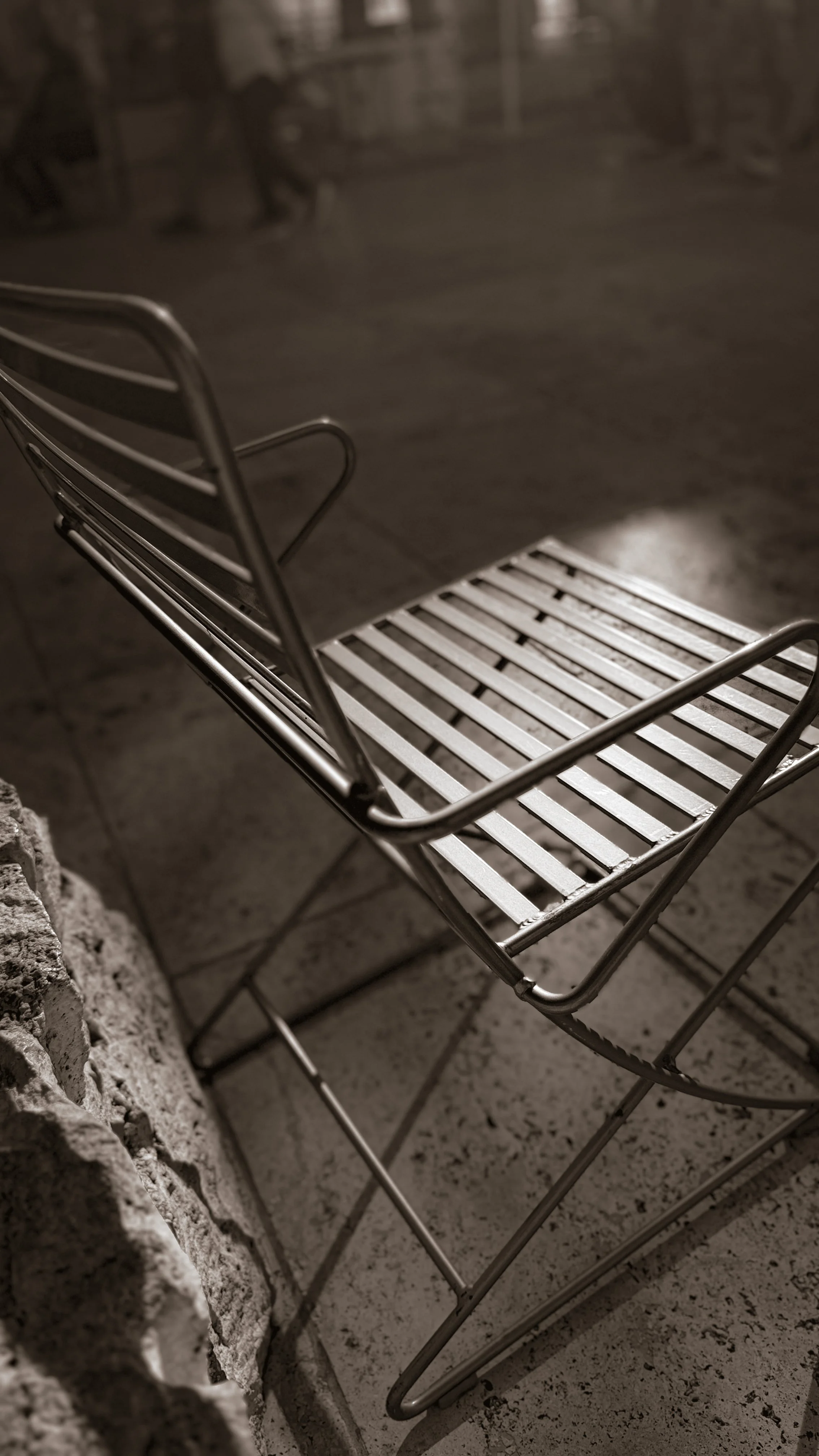Close-up of a metal chair, evoking the quiet before a private Human Design gathering