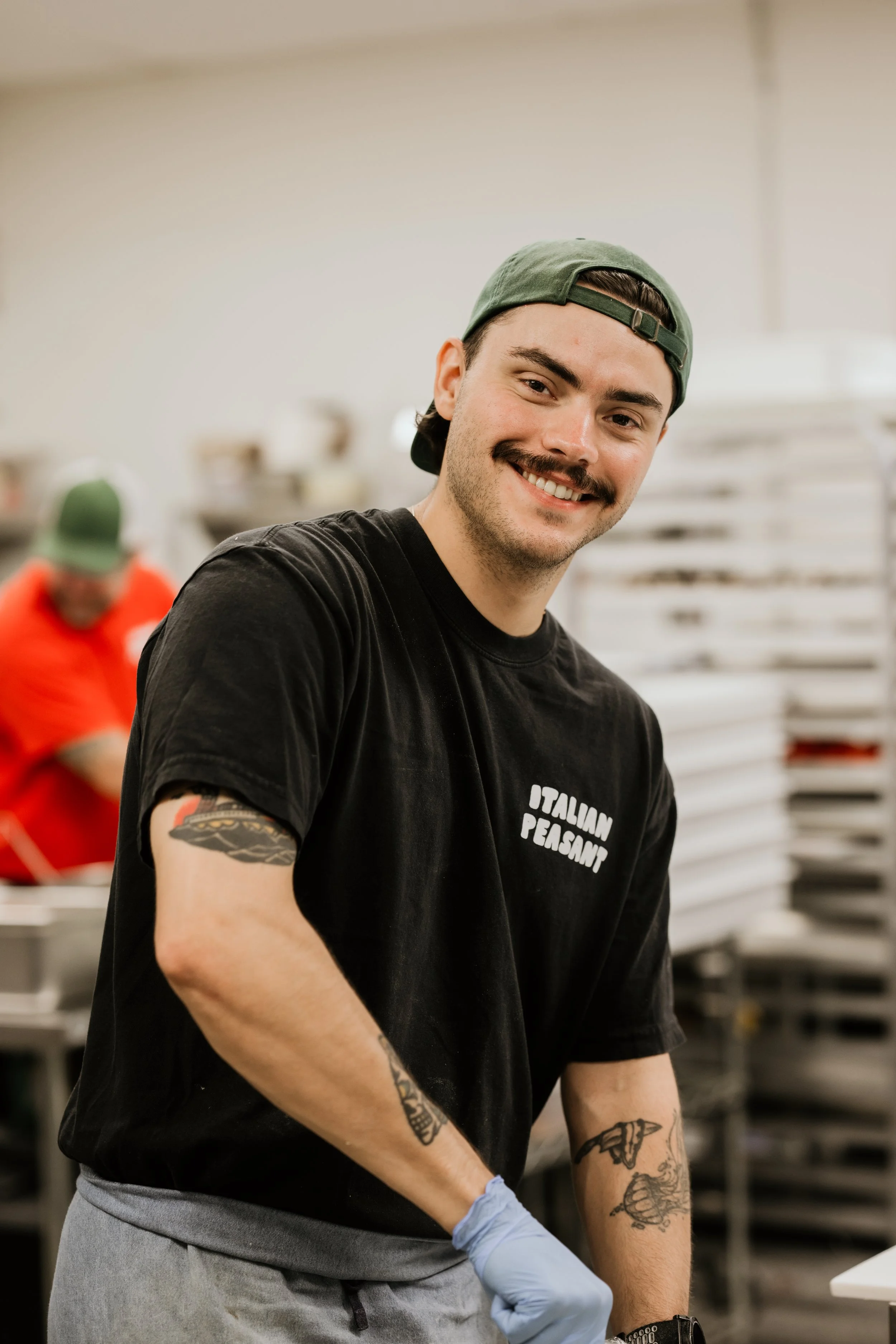 man cooking pizza, sandwiches, fresh bread