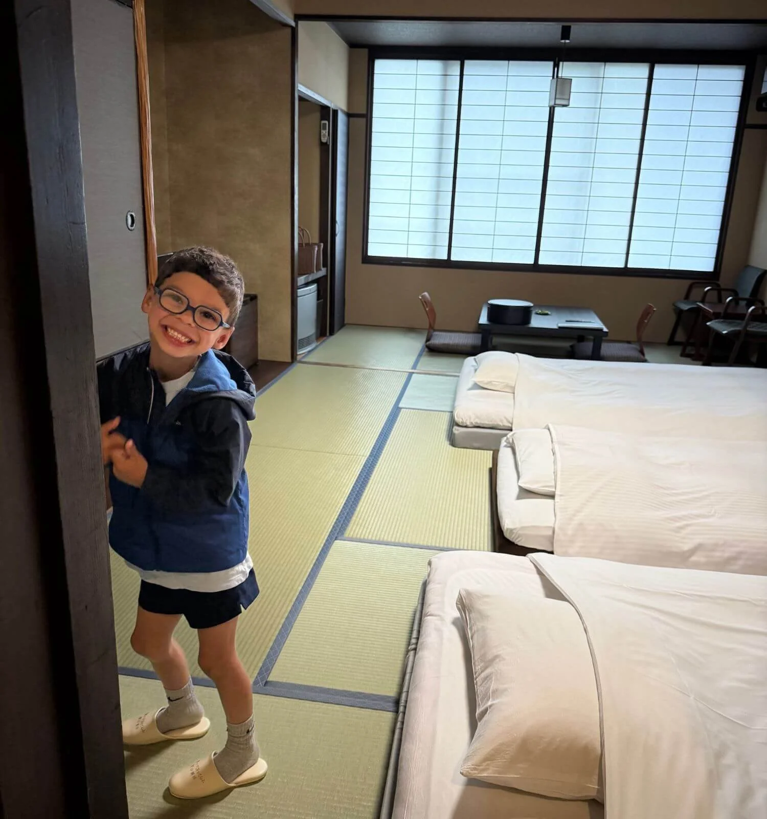 wearing provided slippers on a tatami mat floor in a Japanese room