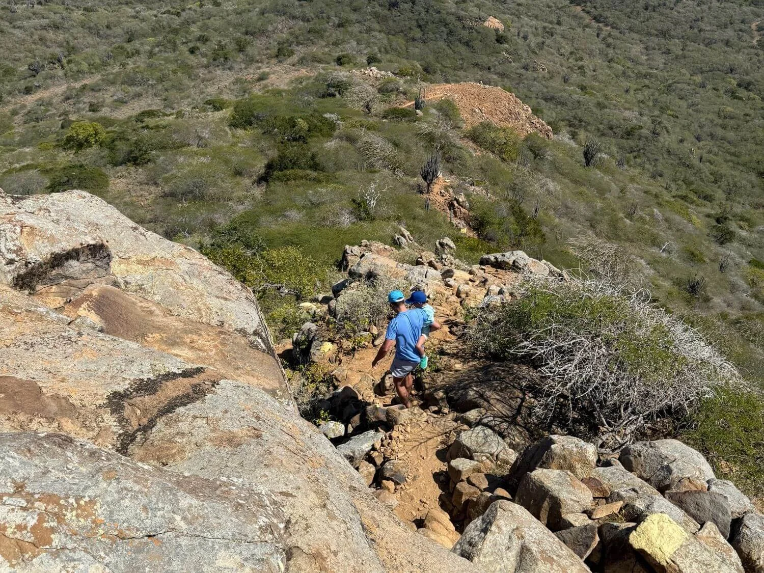 Father and son hiking down Mt. Brandaris in Washington-Slagbaai in Bonaire.