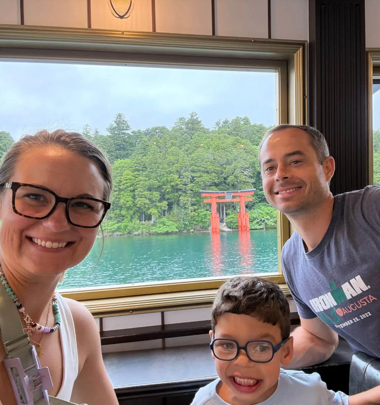 Our family in the first-class cabin of the Hakone pirate ship, with the torii gate visible behind us