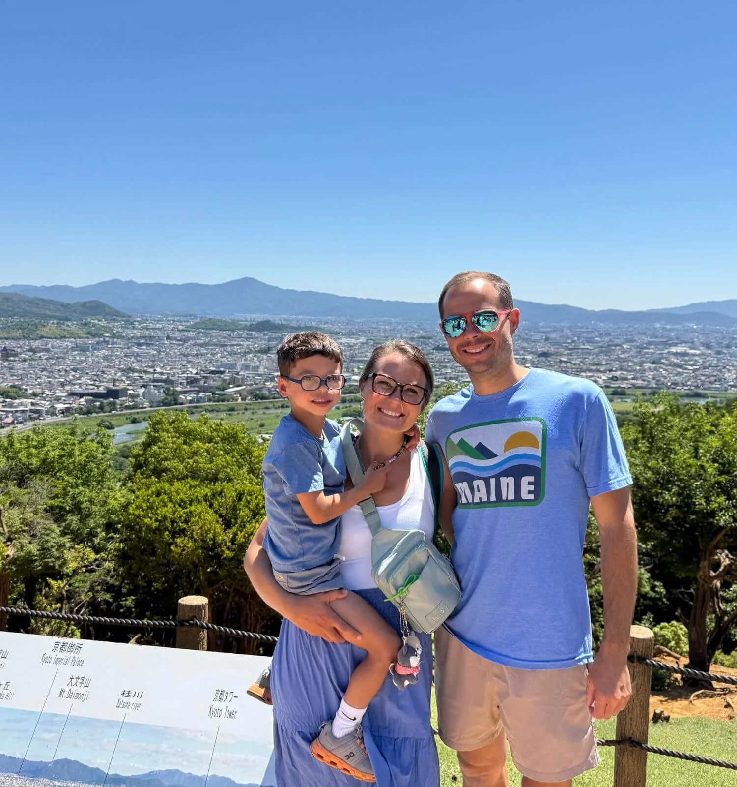 Our family at the top of Arashiyama Monkey Park, with the Kyoto skyline behind us