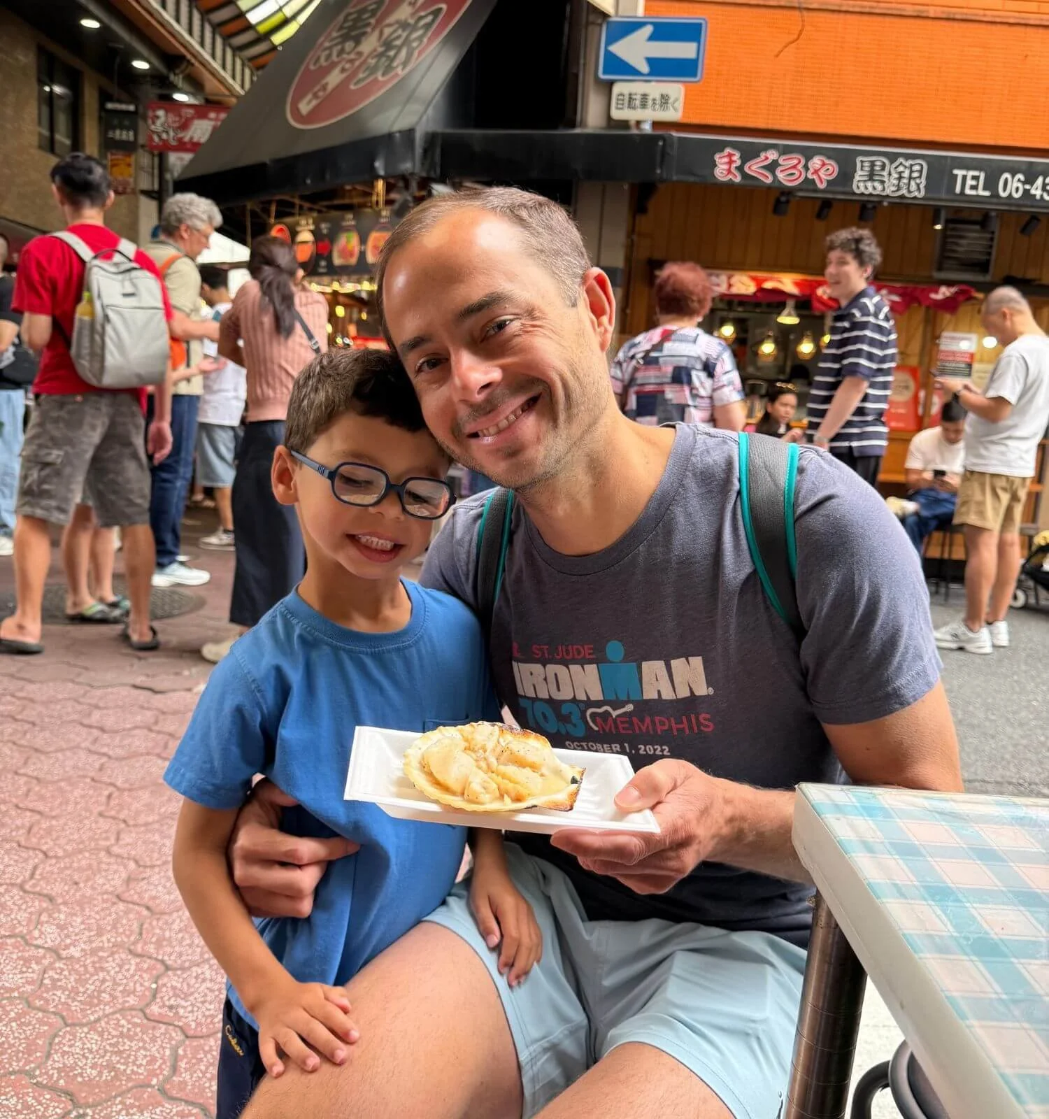 father-son-eating-scallop-kuromon-market-japan.jpg