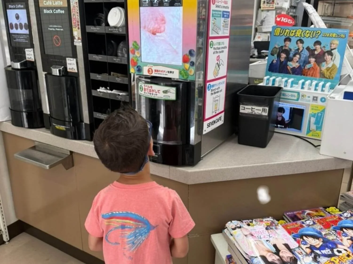 Young boy waiting at a smoothie machine inside a 7-Eleven in Japan