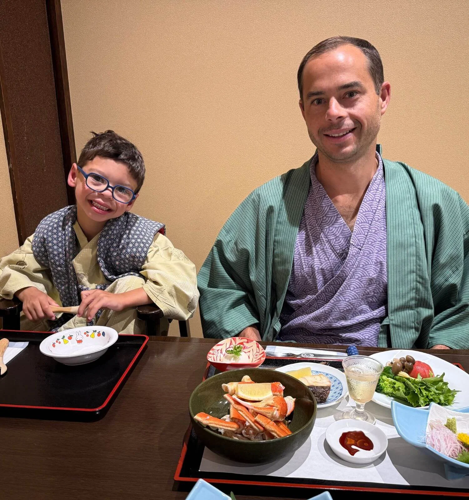 Father and son wearing yukatas at their kaiseki dinner during a stay at Mount View Hakone ryokan in Japan.