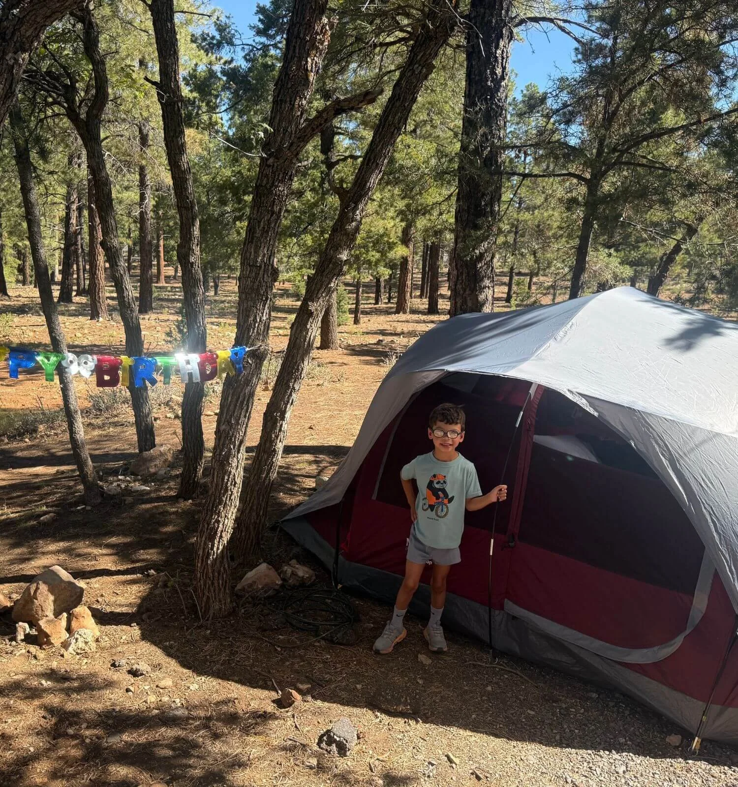 Boy with birthday banner at his campsite in mather campground in the grand canyon national park