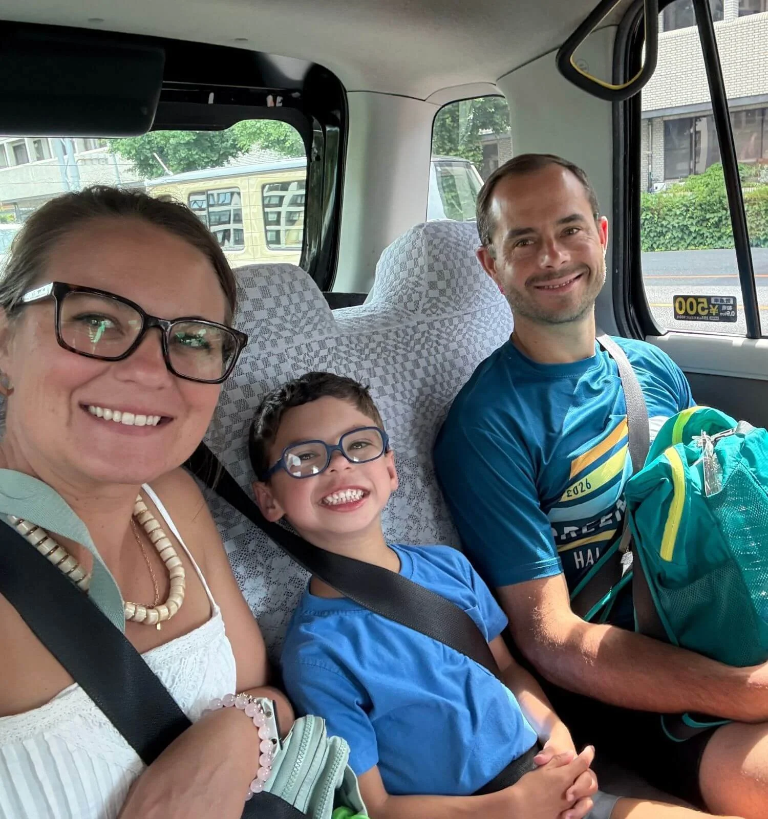 Family of three riding in a taxi in Kyoto, Japan