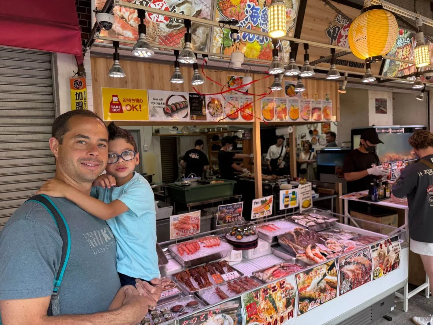 Dad and son at Tsukiji Outer Market in Tokyo, Japan