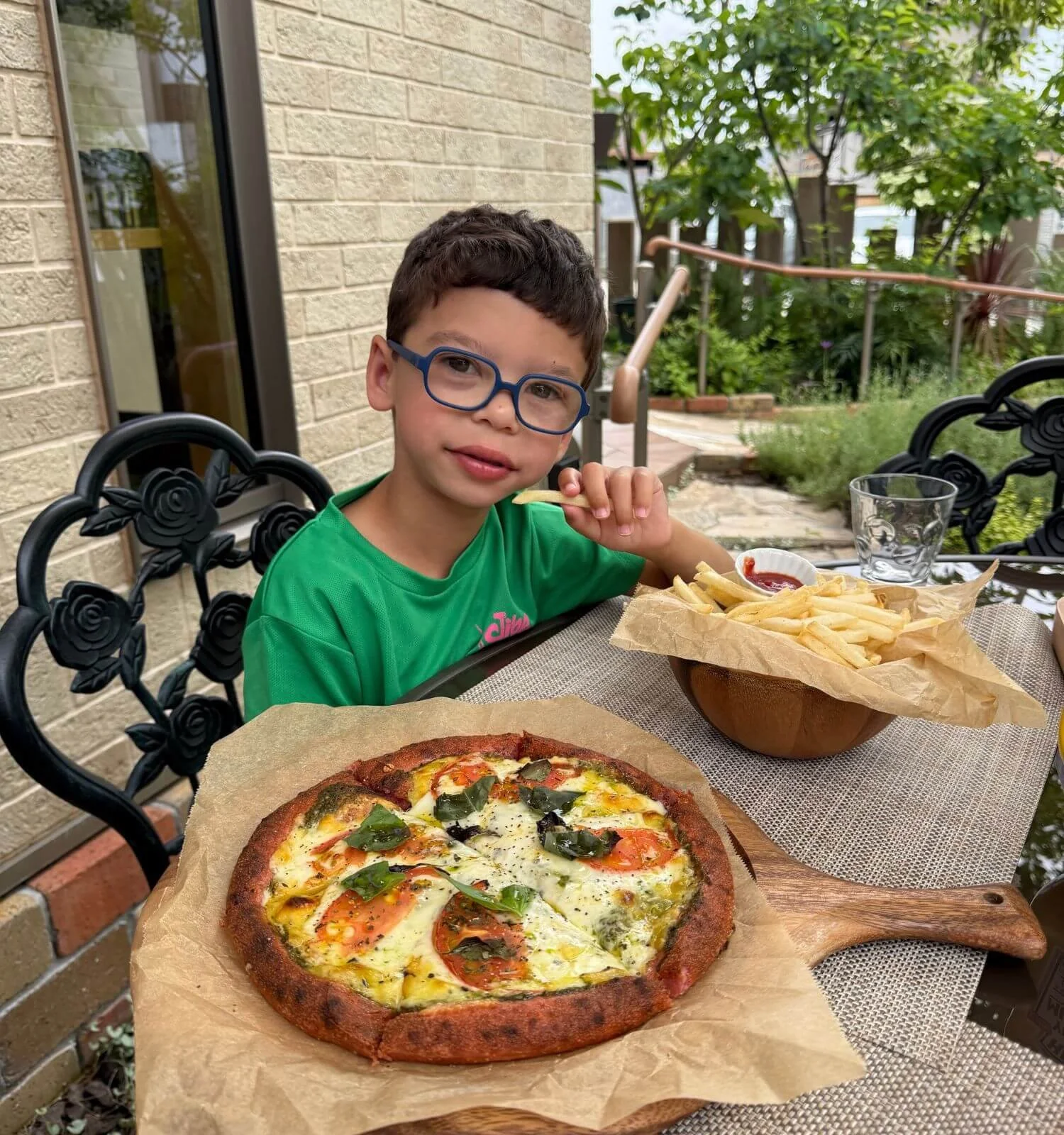 Boy with gluten free pizza and fries at a cafe in Nara Japan
