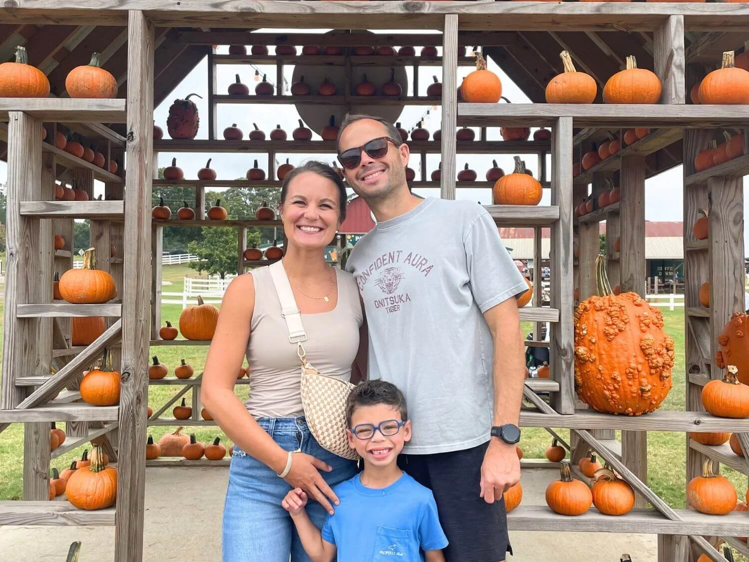 Family of 3 at the pumpkin house at Denver Downs in Anderson, South Carolina.