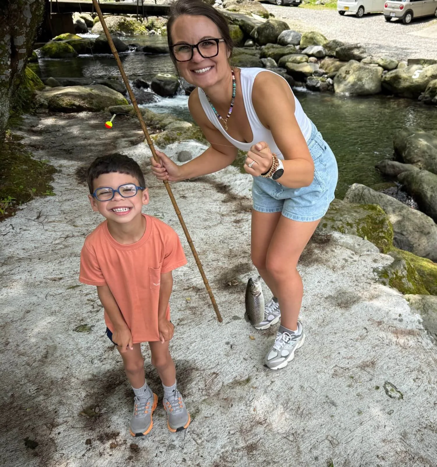 Mother and son holding a freshly caught trout at a trout fishing spot in Hakone, Japan