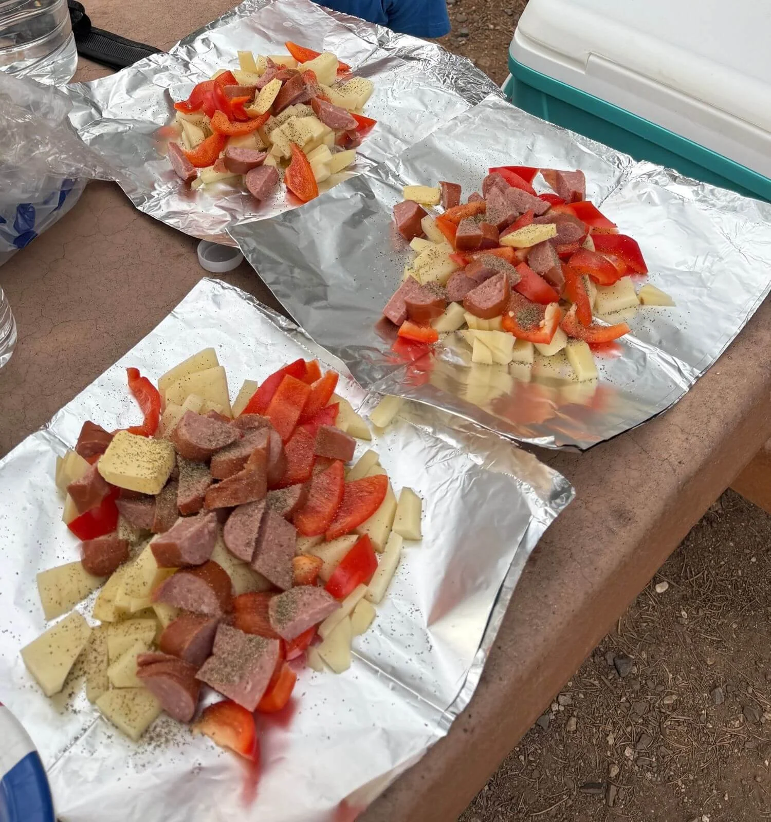 Image of sausage, potatoes, and peppers in a foil pack cooked for dinner at Mather campground in the Grand Canyon National Park in Arizona, USA.