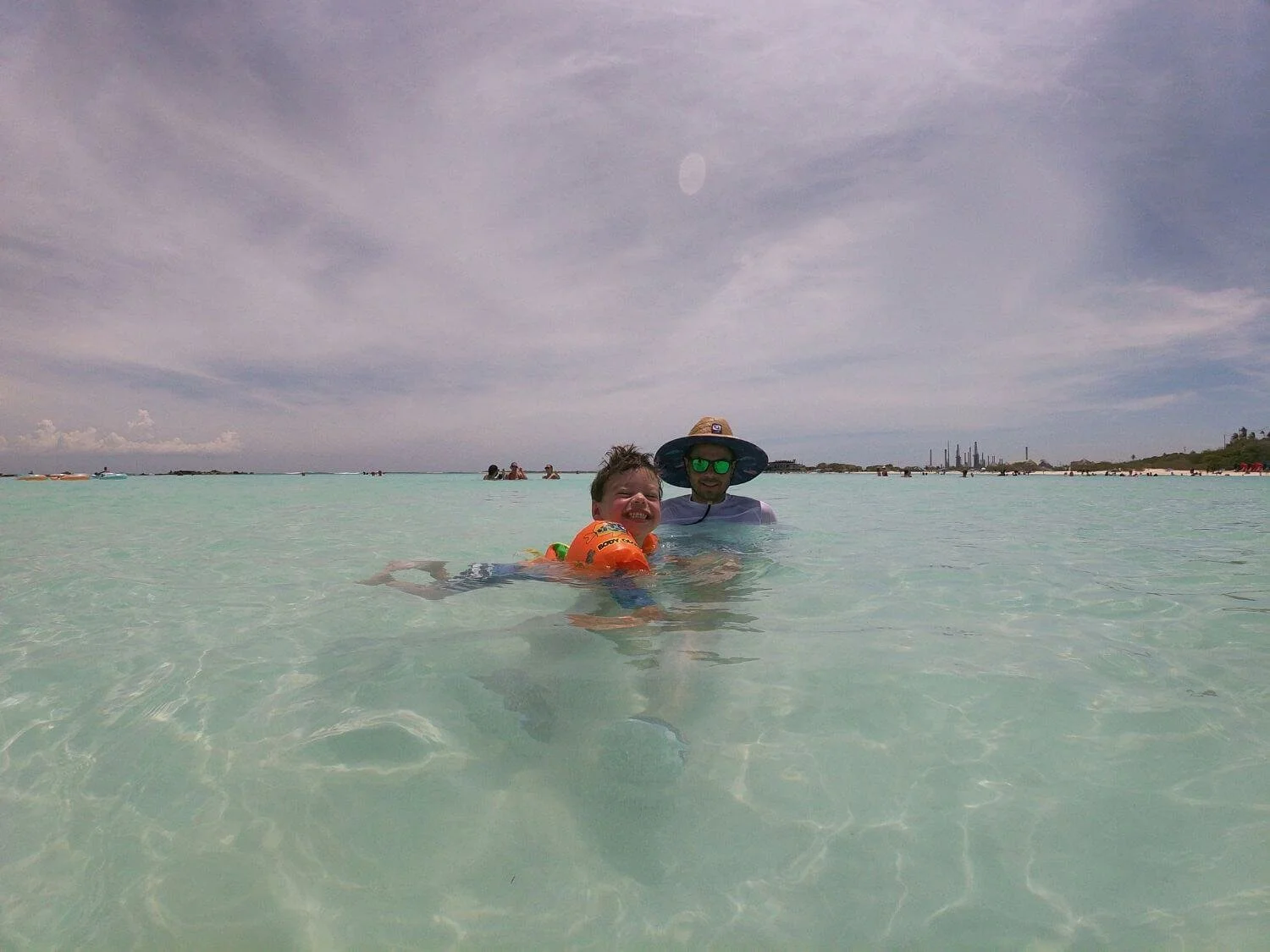 Father and son swimming at Baby Beach in Aruba.