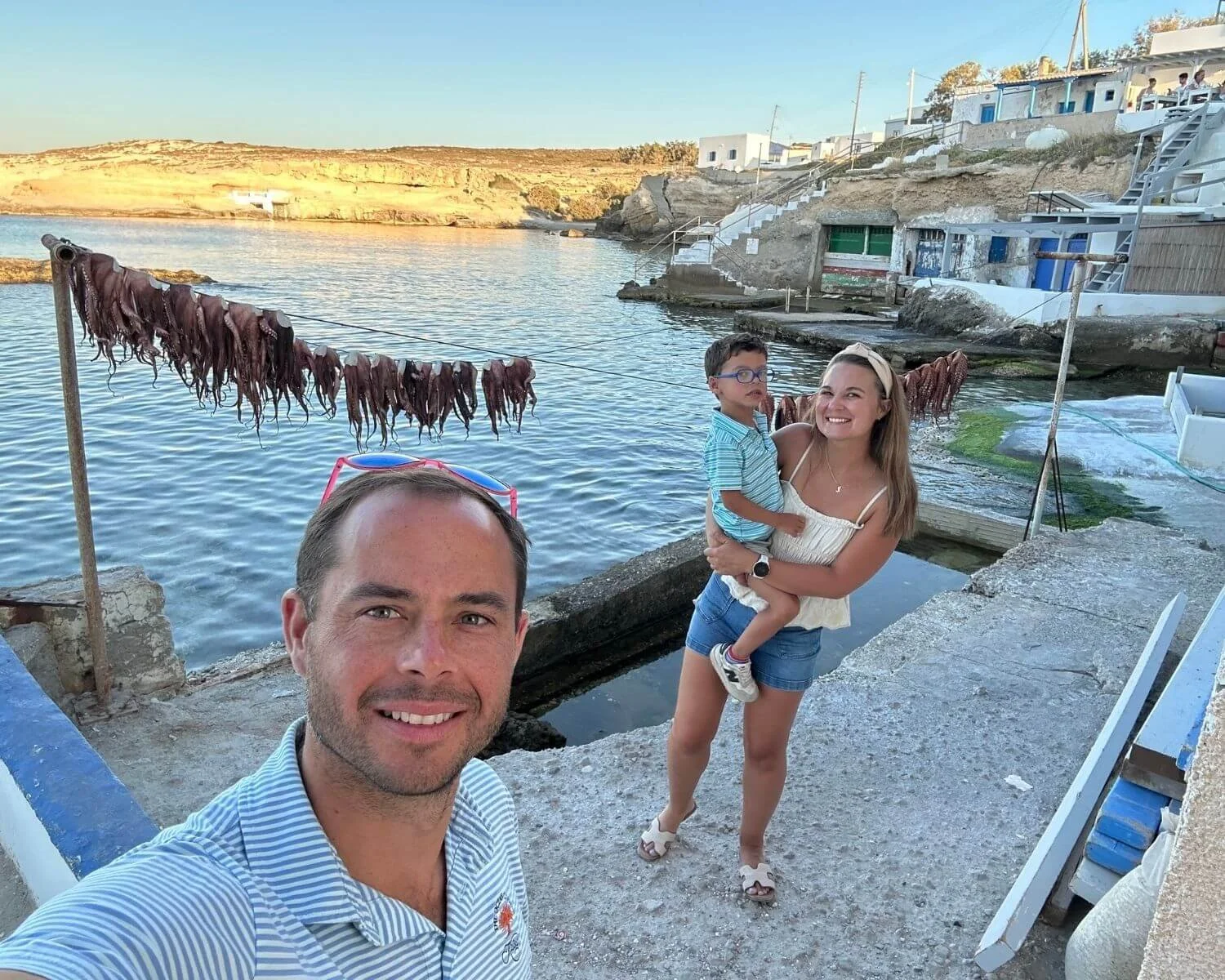 Family by traditional drying octopus on the waterfront in Milos, Greece - explore our Europe travel guides