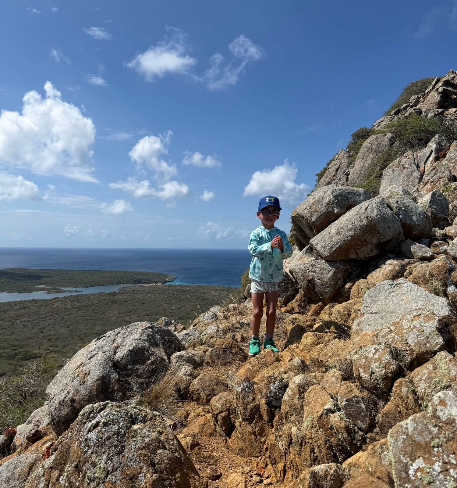 Boy at the top of Mount Brandaris in Washington-Slagbaai National Park in Bonaire.