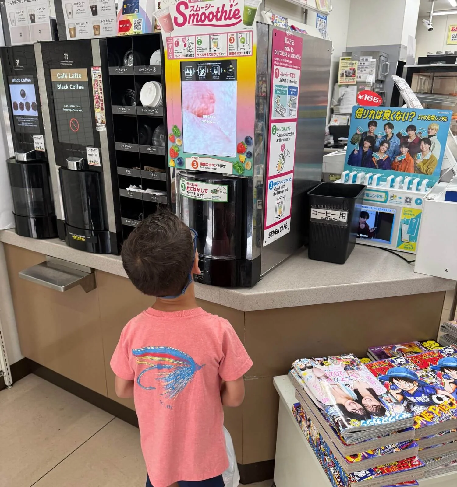 Boy waiting on smoothie to be made at seven eleven in Japan
