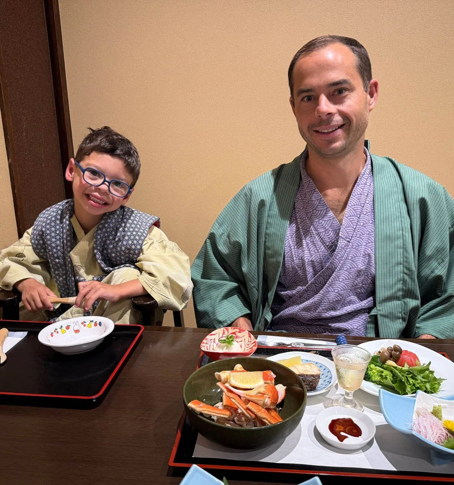 Father and son wearing yukatas during a kaiseki dinner at their ryokan in Hakone, Japan.