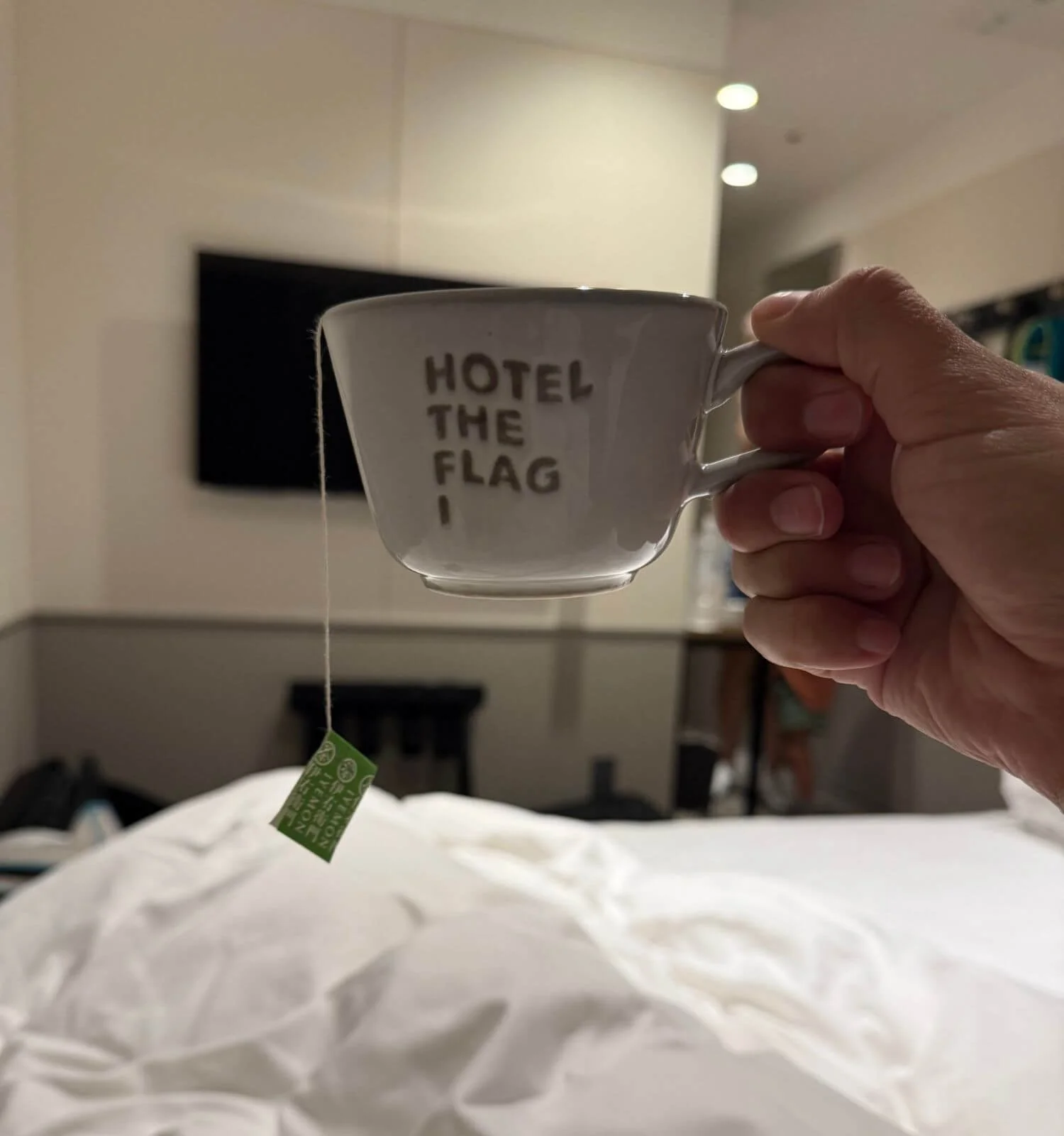 Mom relaxing in bed with a cup of tea in our hotel room in Osaka, Japan.