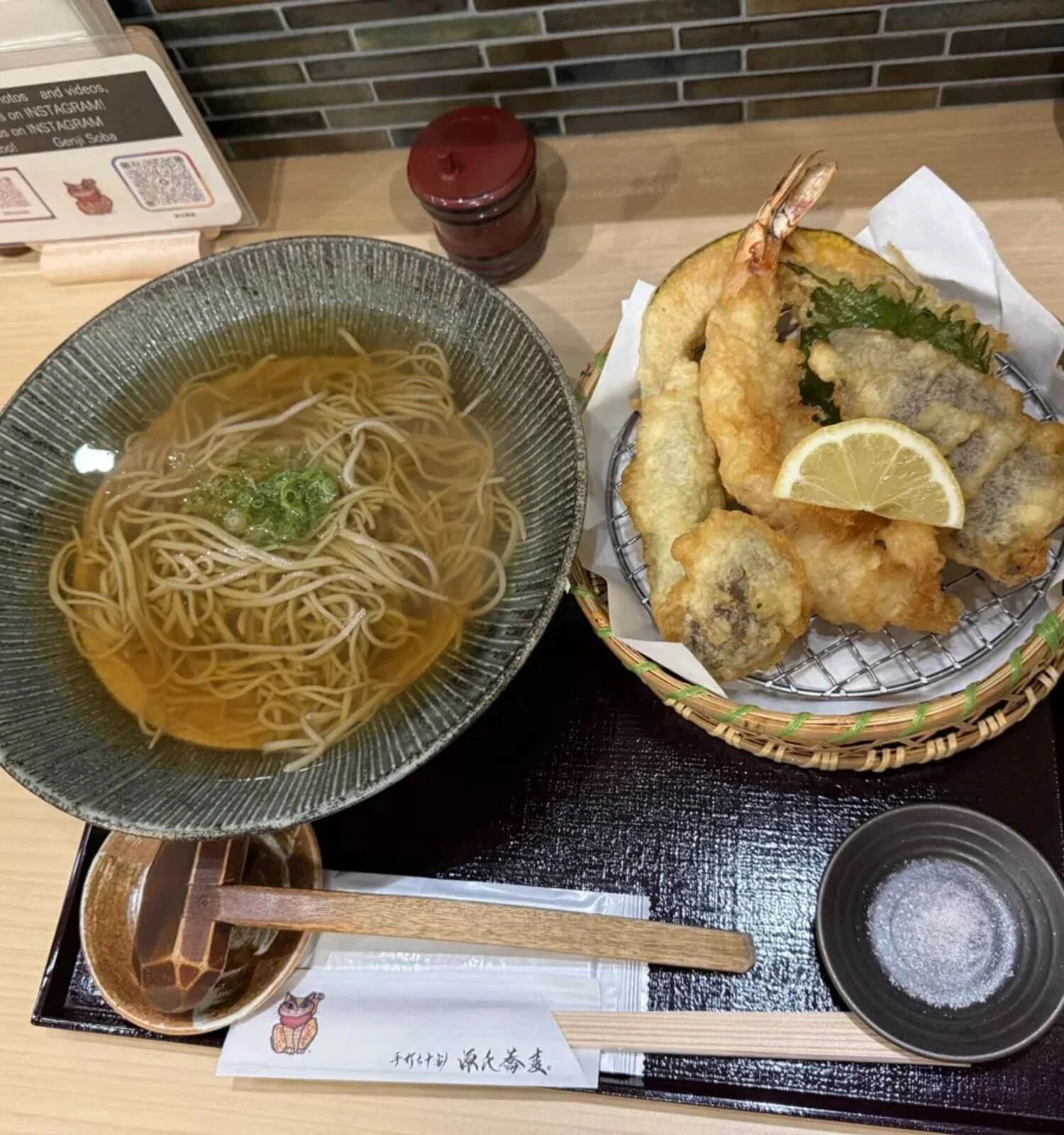 Gluten-free soba noodles in broth served alongside a tempura basket at Genji Soba in Osaka, Japan