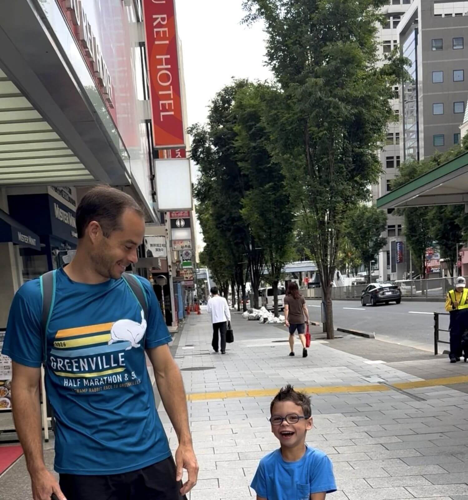 Boy and his dad standing outside of their hotel room Shibuya Tokyu REI Hotel in Tokyo, Japan during a 14 day international trip to the country.
