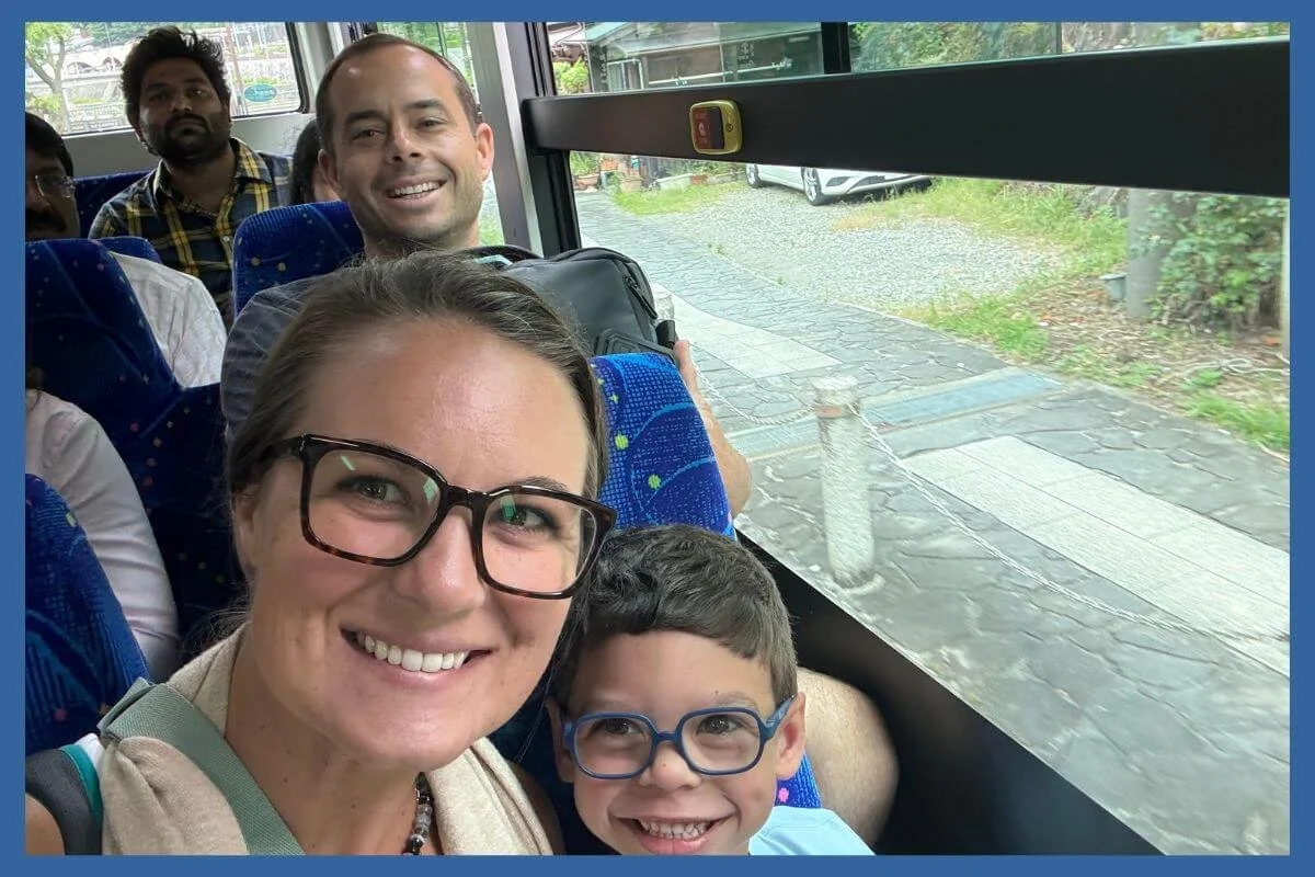 Family riding a bus in Japan using a Suica card for transportation
