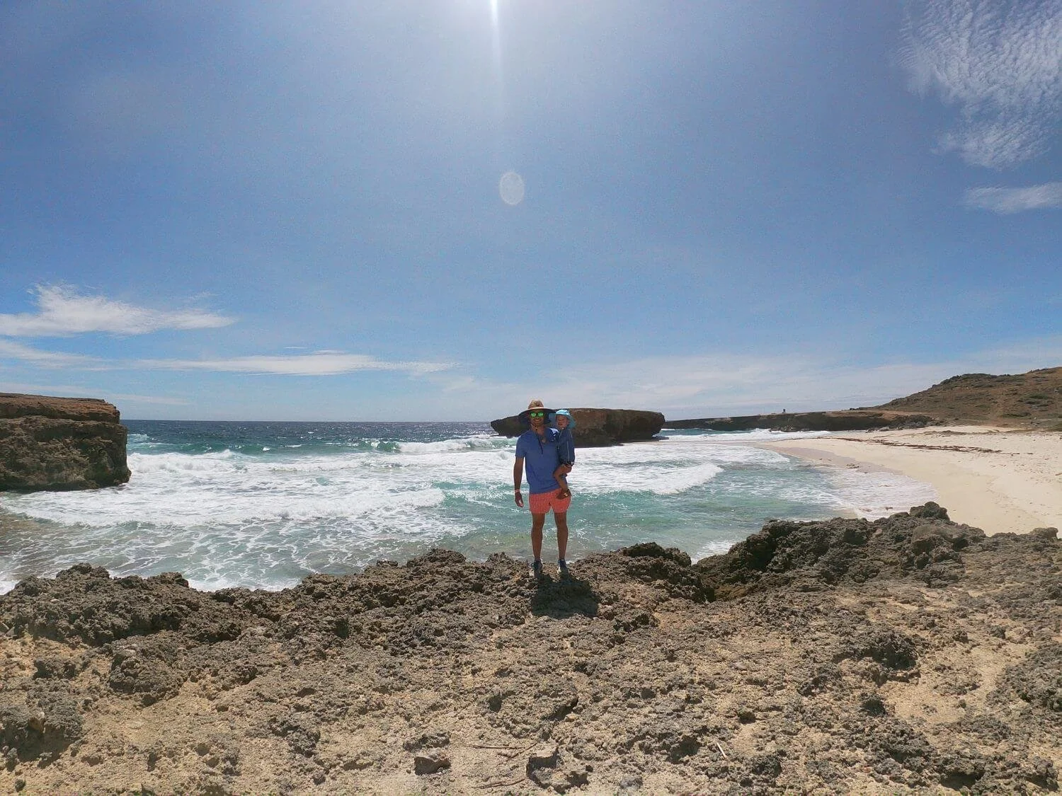Father and son on a hike to Conchi natural pool in Aruba.