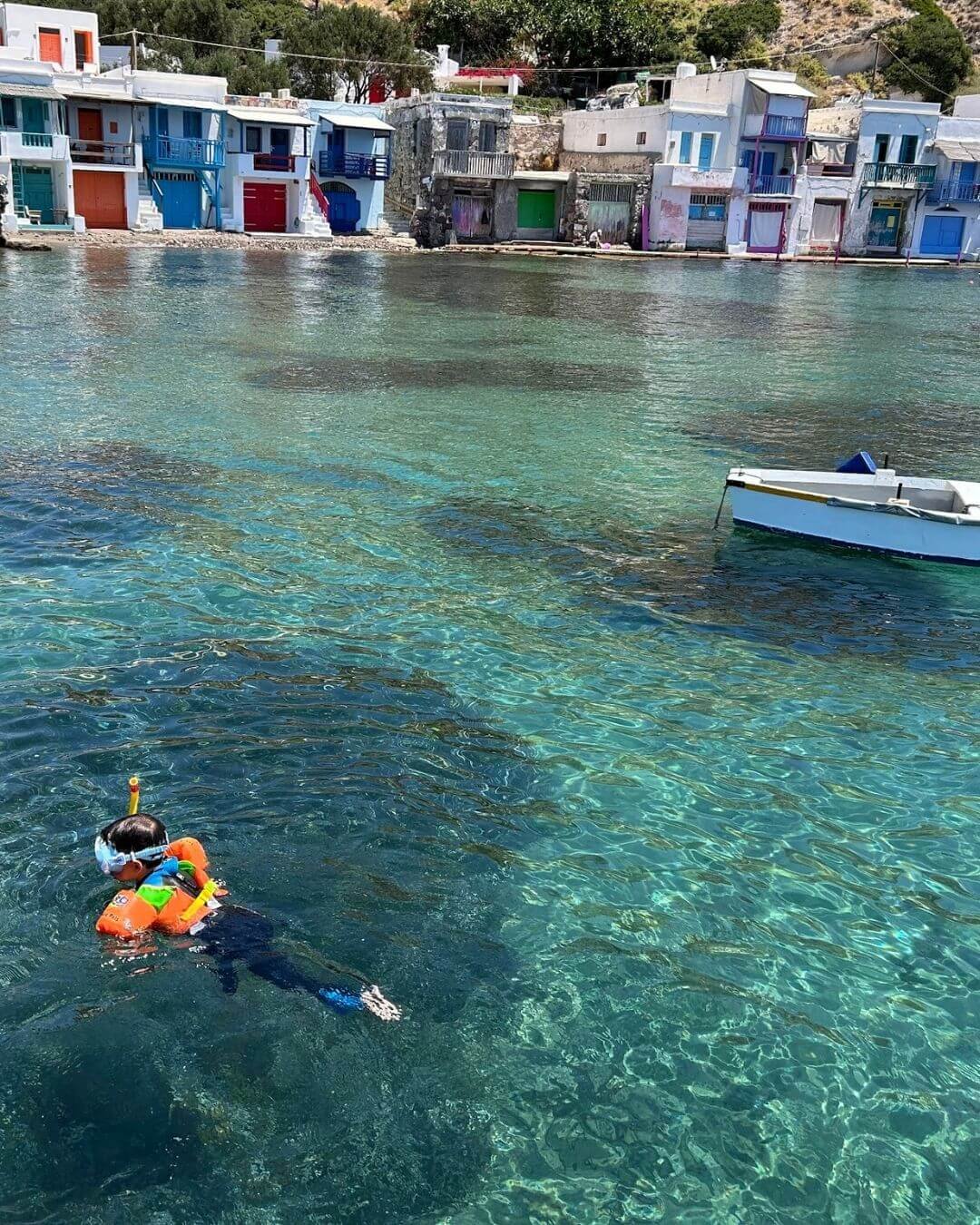 Child snorkeling in the harbor of Milos, Greece - read our travel blog