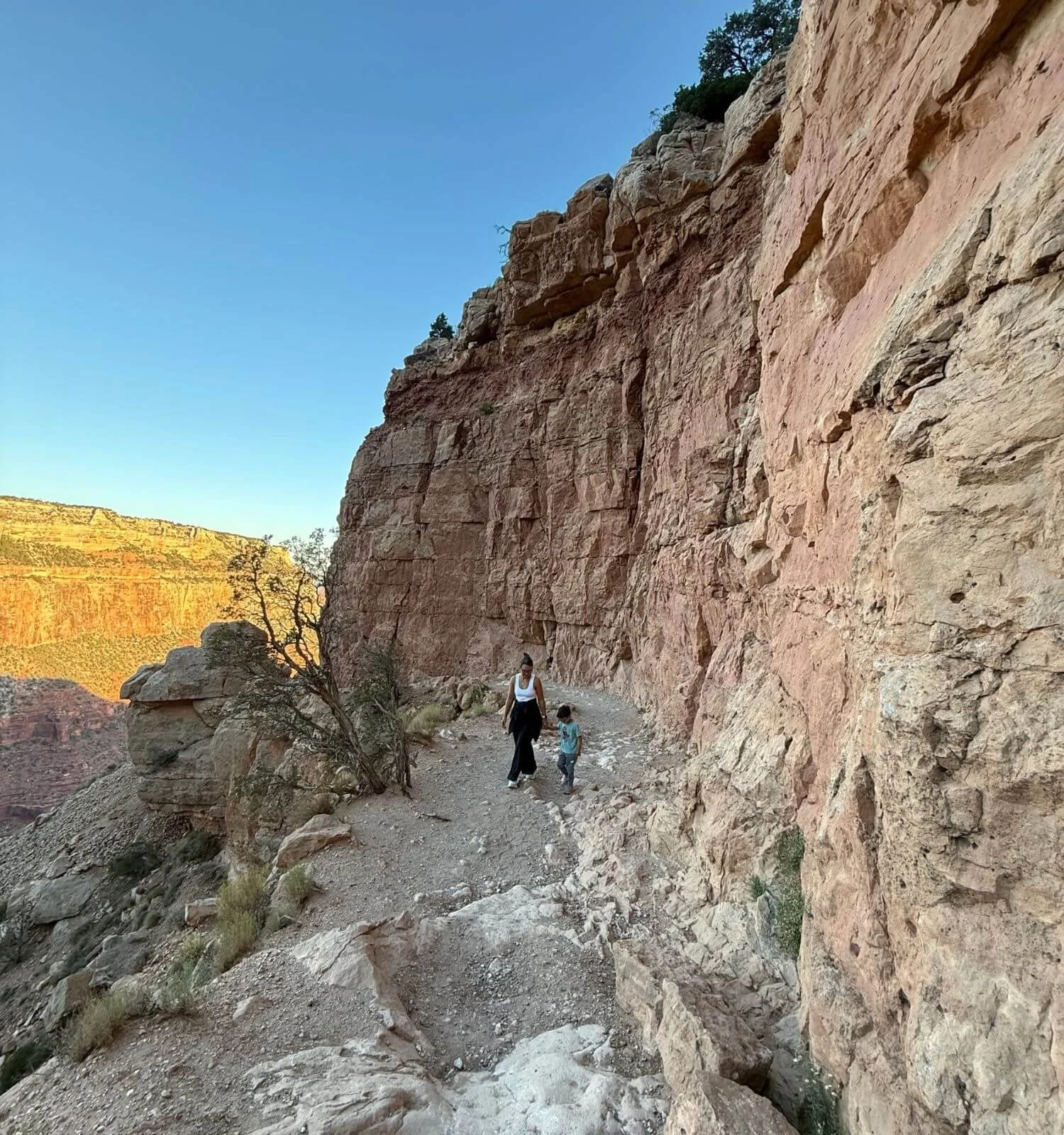 Mother and son hiking back out from Ooh Aah Point on South Kaibab Trail in the Grand Canyon National Park, Arizona USA.