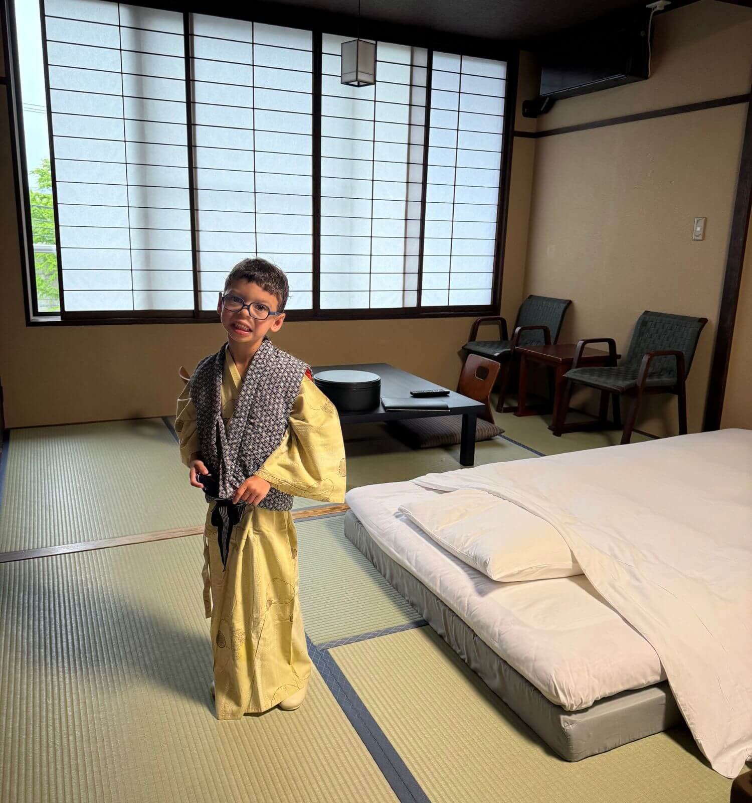 Boy wearing a yukata inside his traditional Japanese ryonkan in Hakone.
