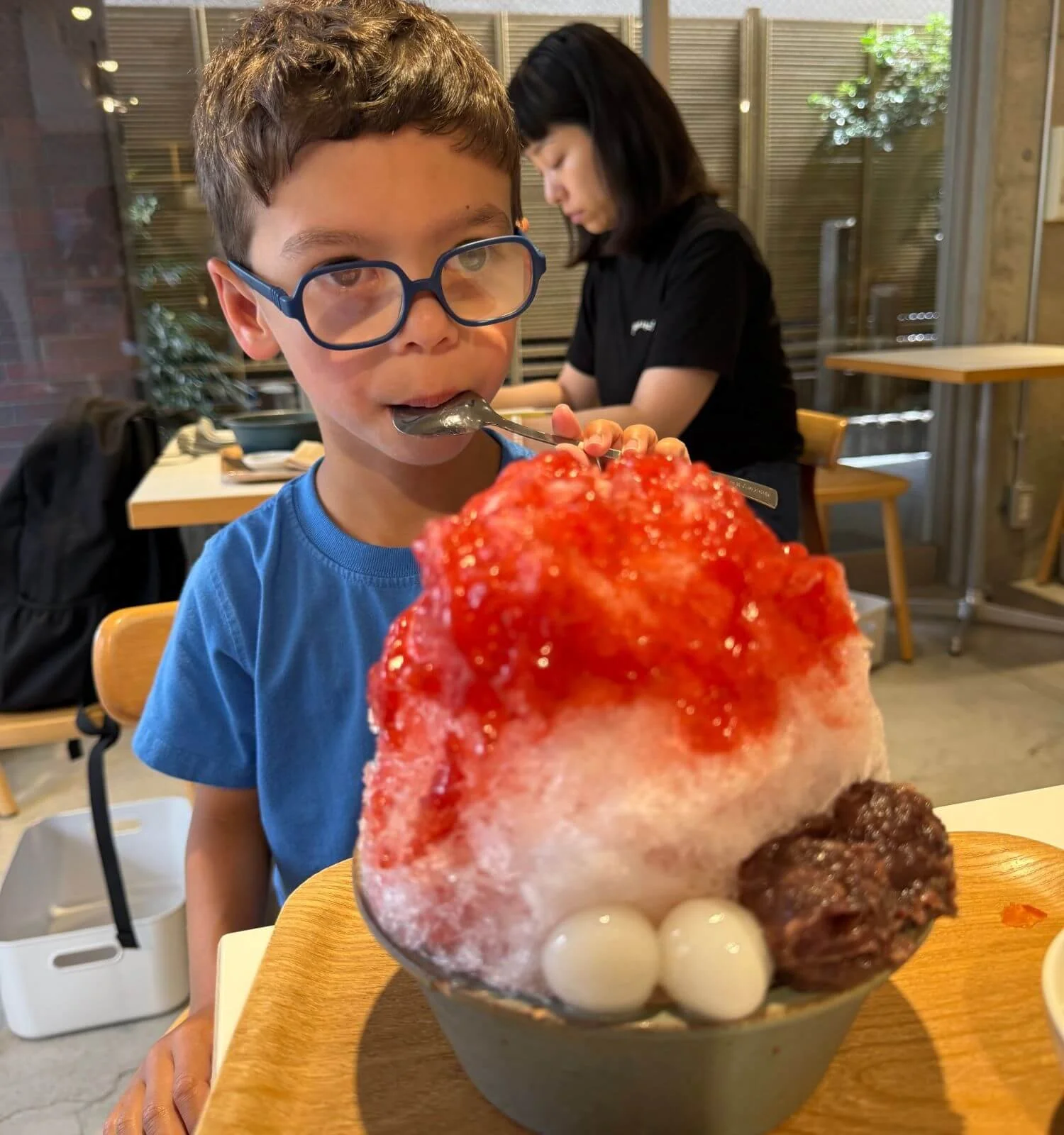 boy eating kakigōri while on a family trip to Kyoto Japan