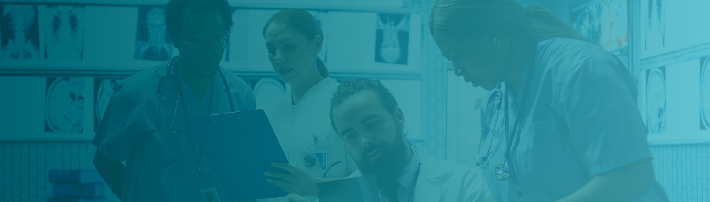 Healthcare professionals reviewing information together in a clinical setting.