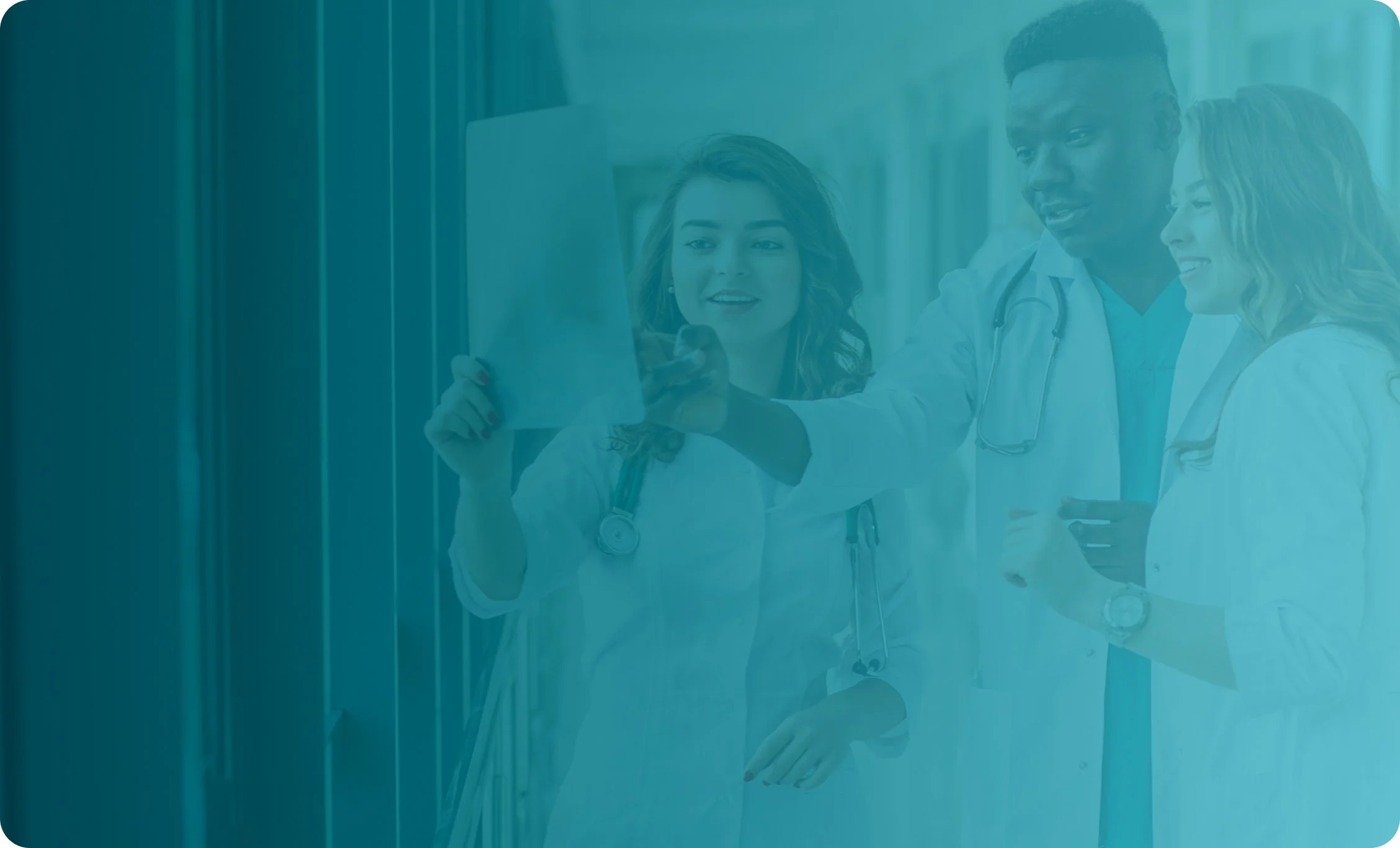 Two healthcare professionals reviewing information on a tablet together in a clinical setting.