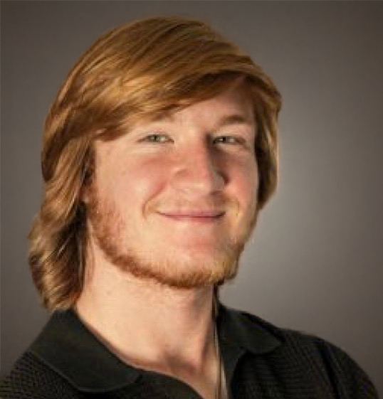 A young man with light skin, red hair, and a beard, smiling in a portrait photo against a plain background.