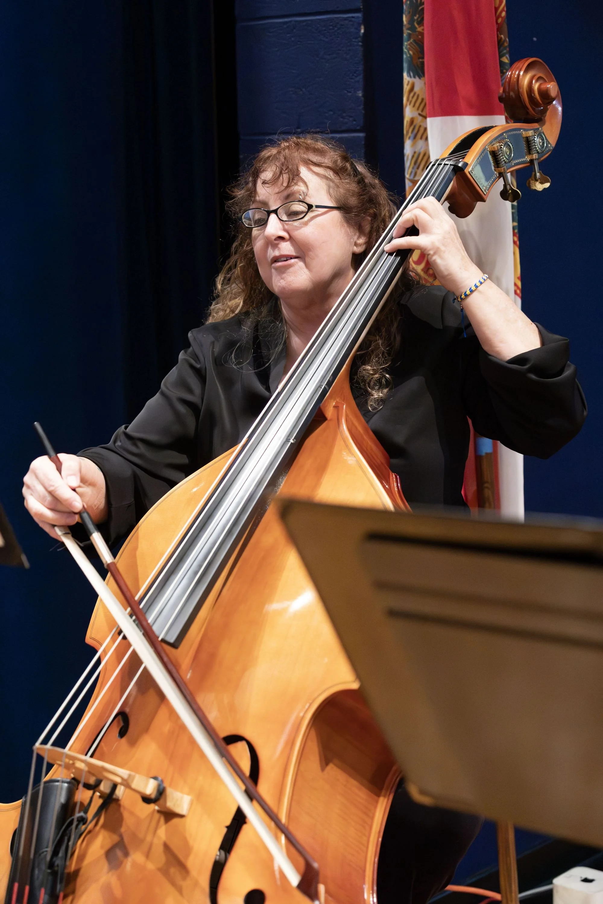 A woman playing a double bass during a performance.